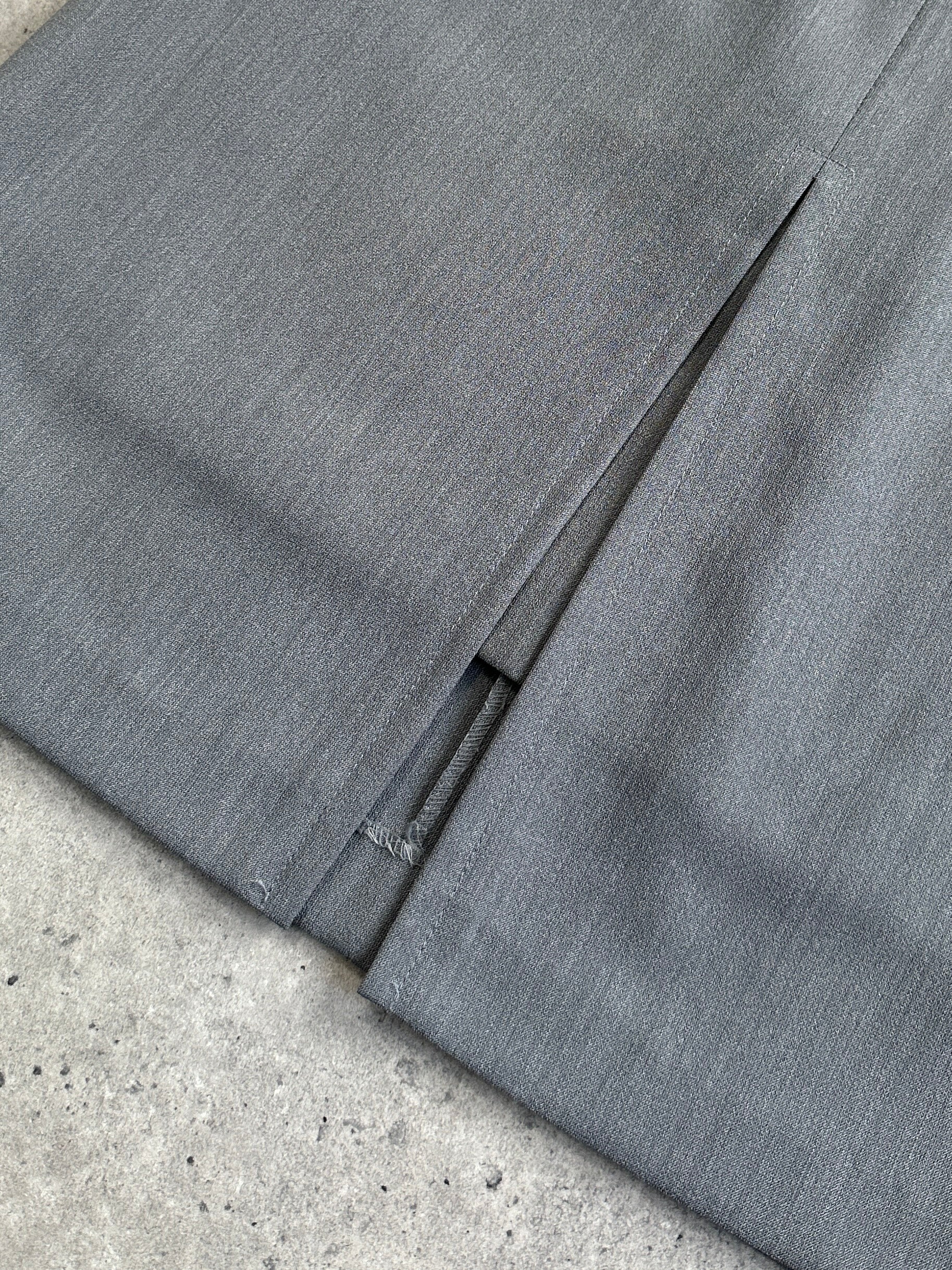 Vintage Italian double-layered front split mini skirt in black, showing its layered design and front slit detail.