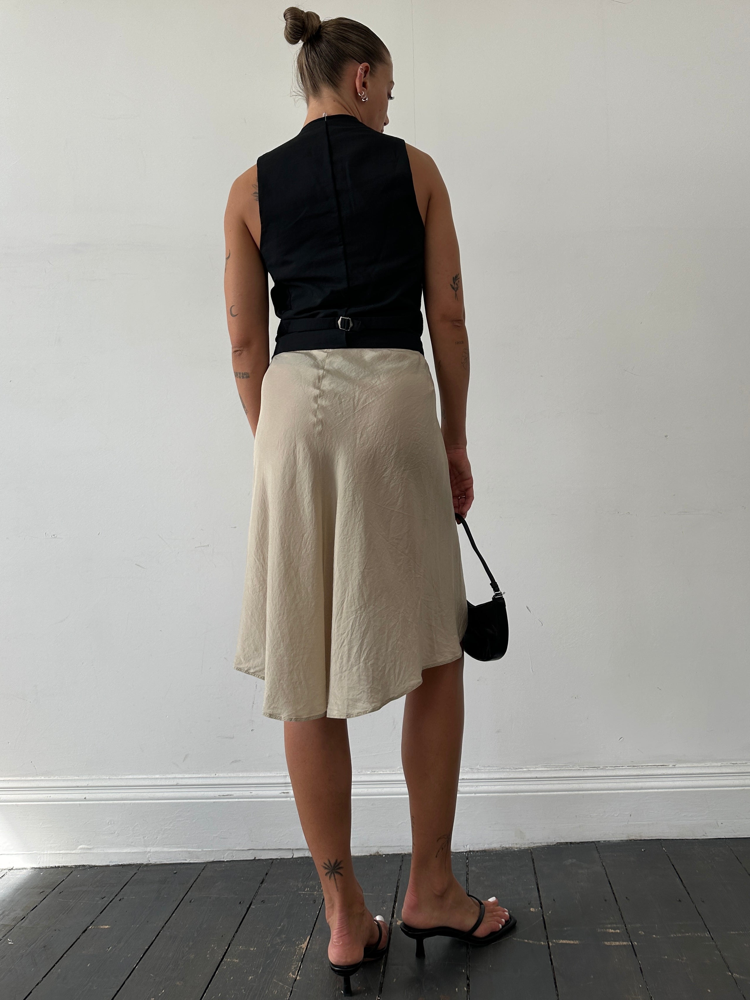 Max Mara pure silk wrap skirt in W27, showing elegant drape and smooth fabric in a neutral color.