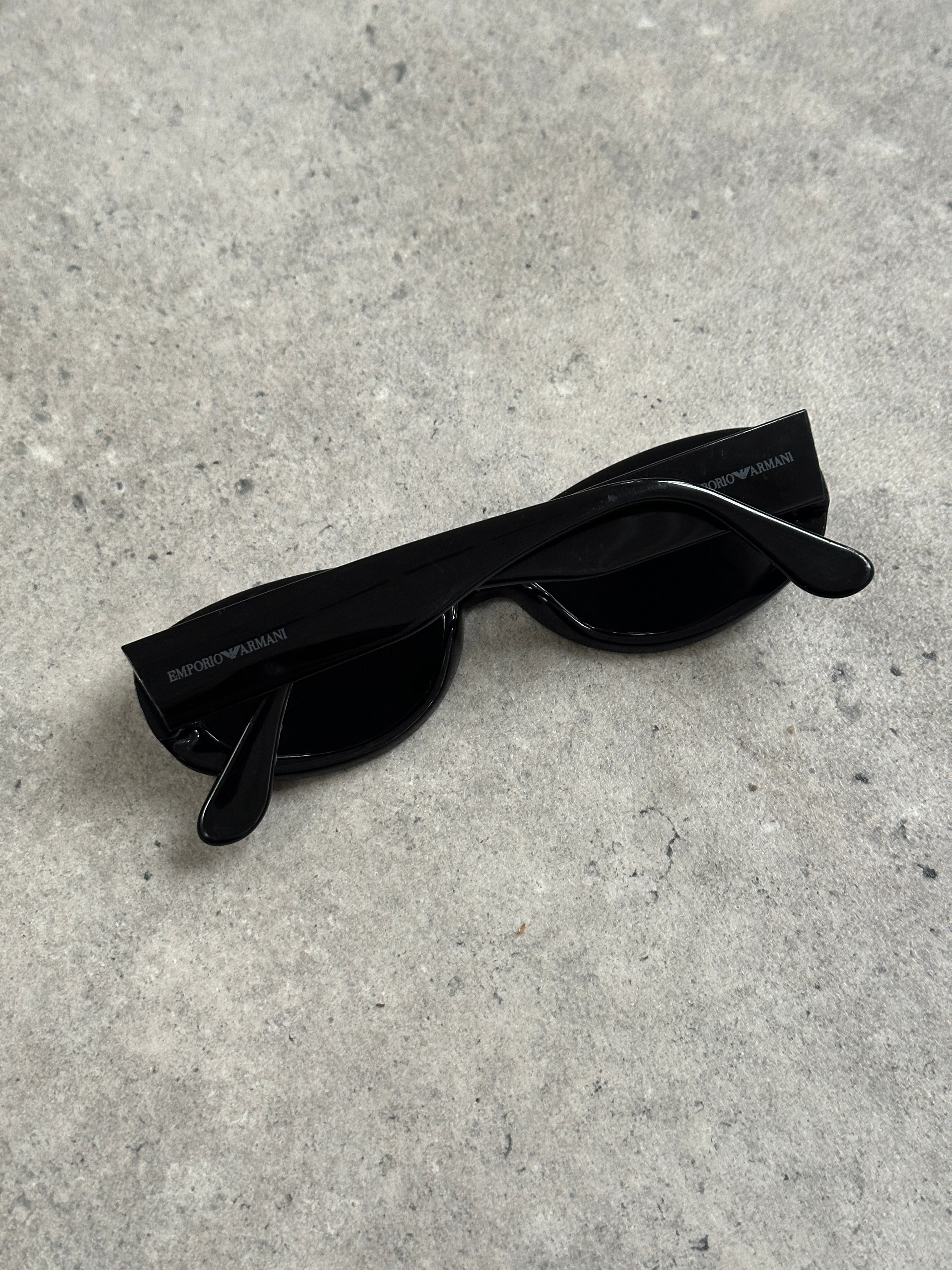 Emporio Armani 2000s oval sunglasses with dark tinted lenses and sleek black frames, stylish eyewear for everyday wear.