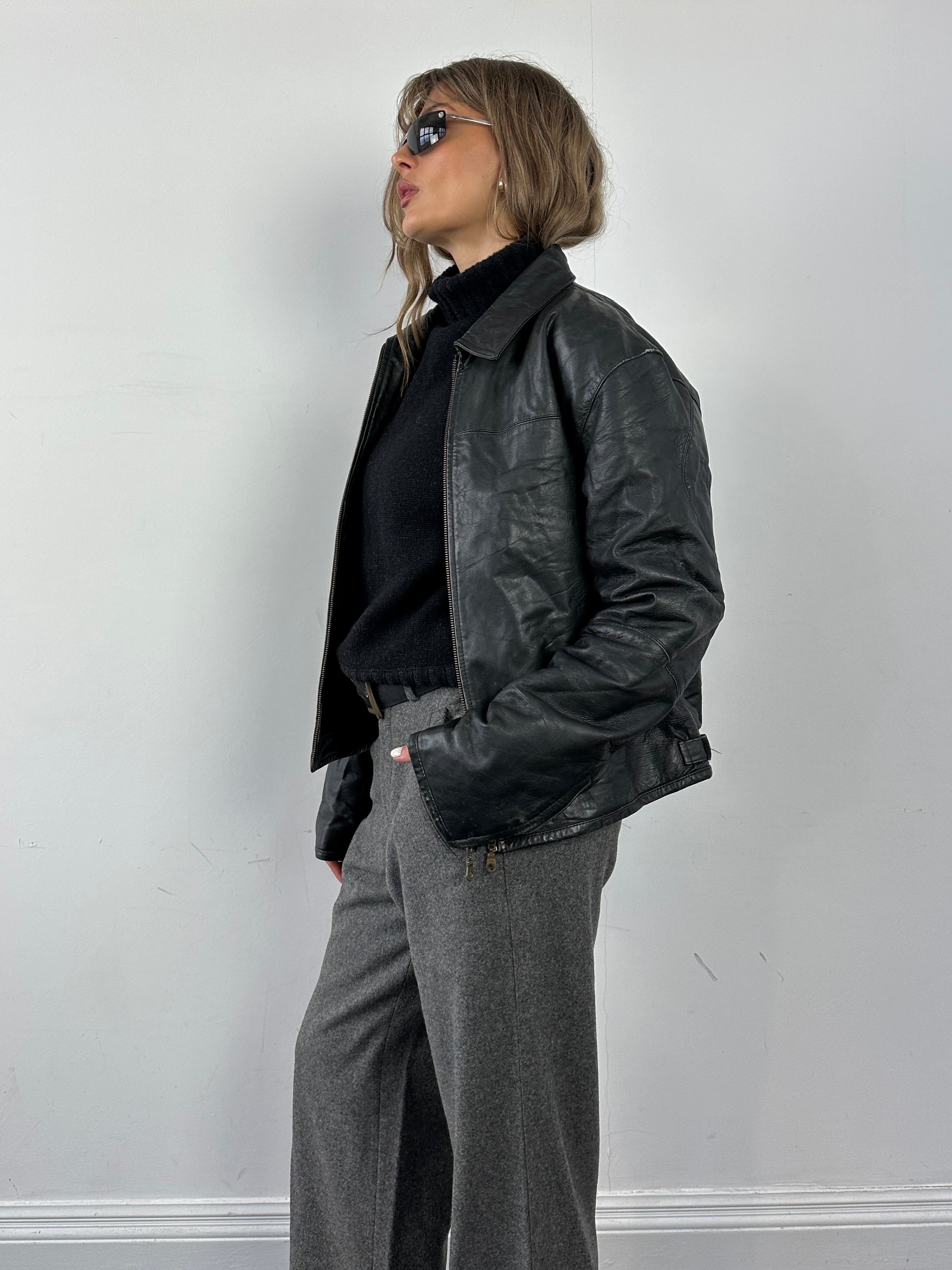 Conbipel leather jacket in size M/L, stylish black leather outerwear with a classic fit and smooth finish.
