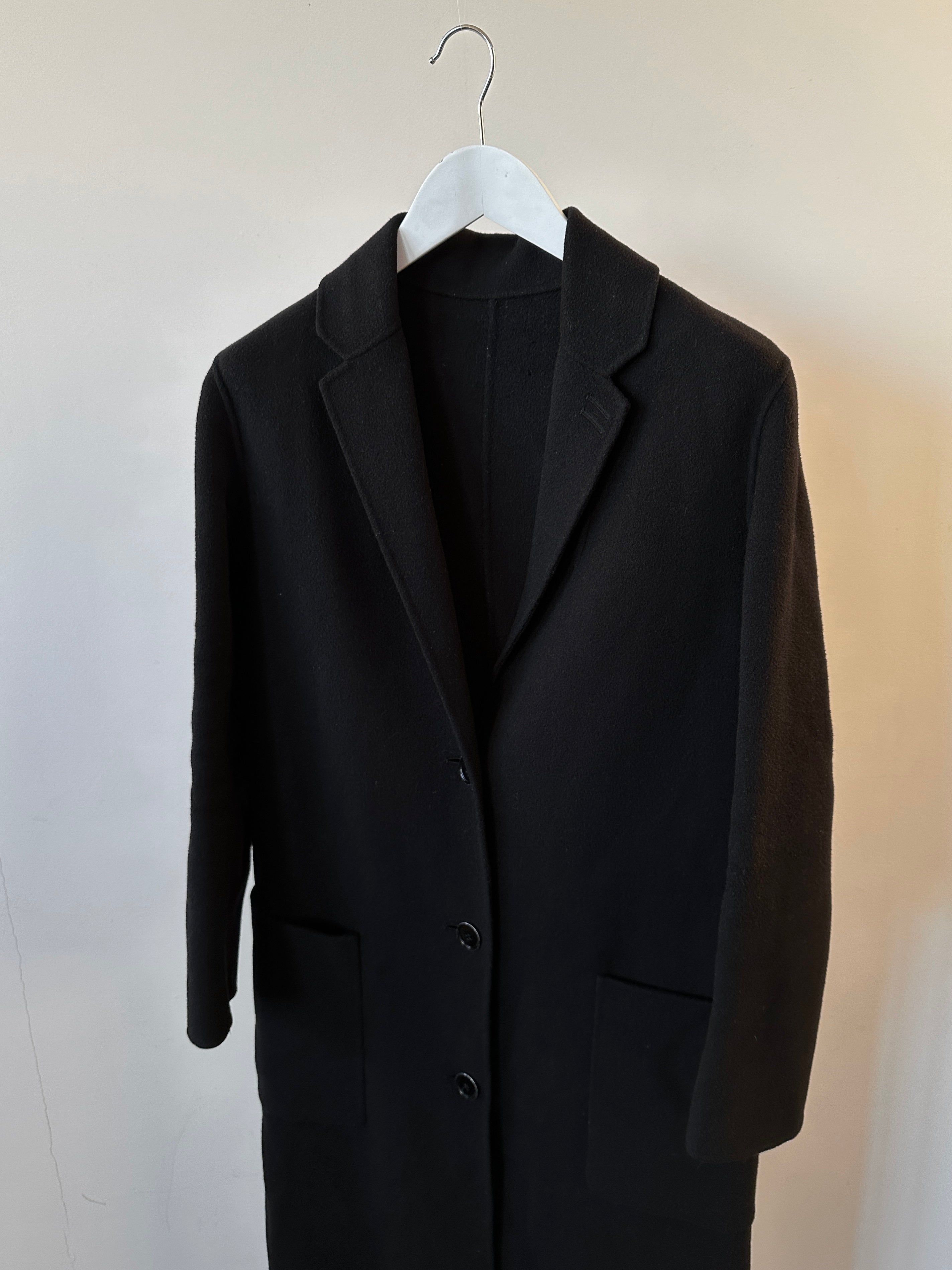The Kooples double-faced pure wool unlined coat in XS/S, floor-length with a classic collar and tailored fit, shown on a hanger.