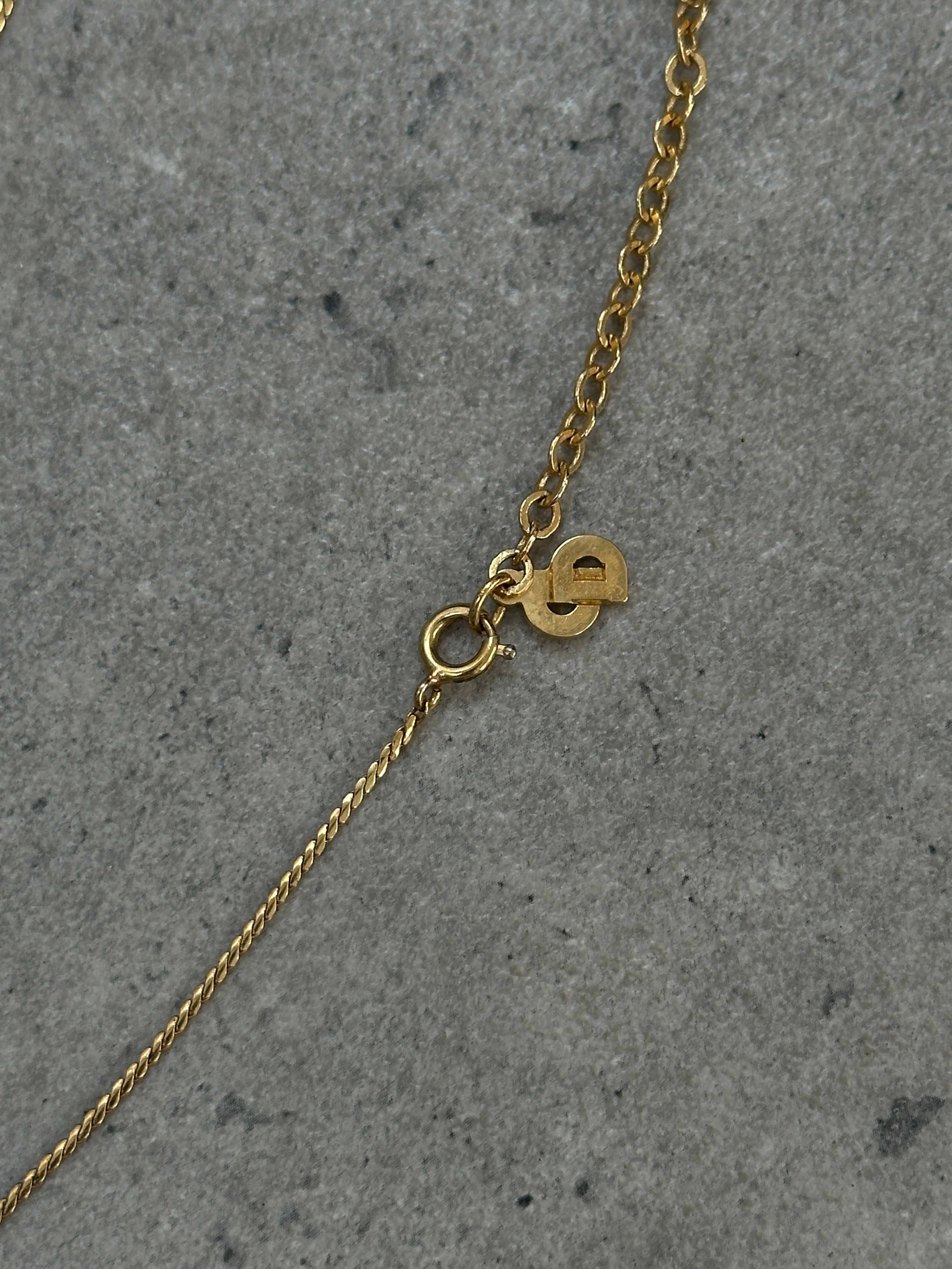 Christian Dior 16-inch gold plated logo pendant necklace featuring a sleek, elegant chain and a prominent Dior logo pendant.