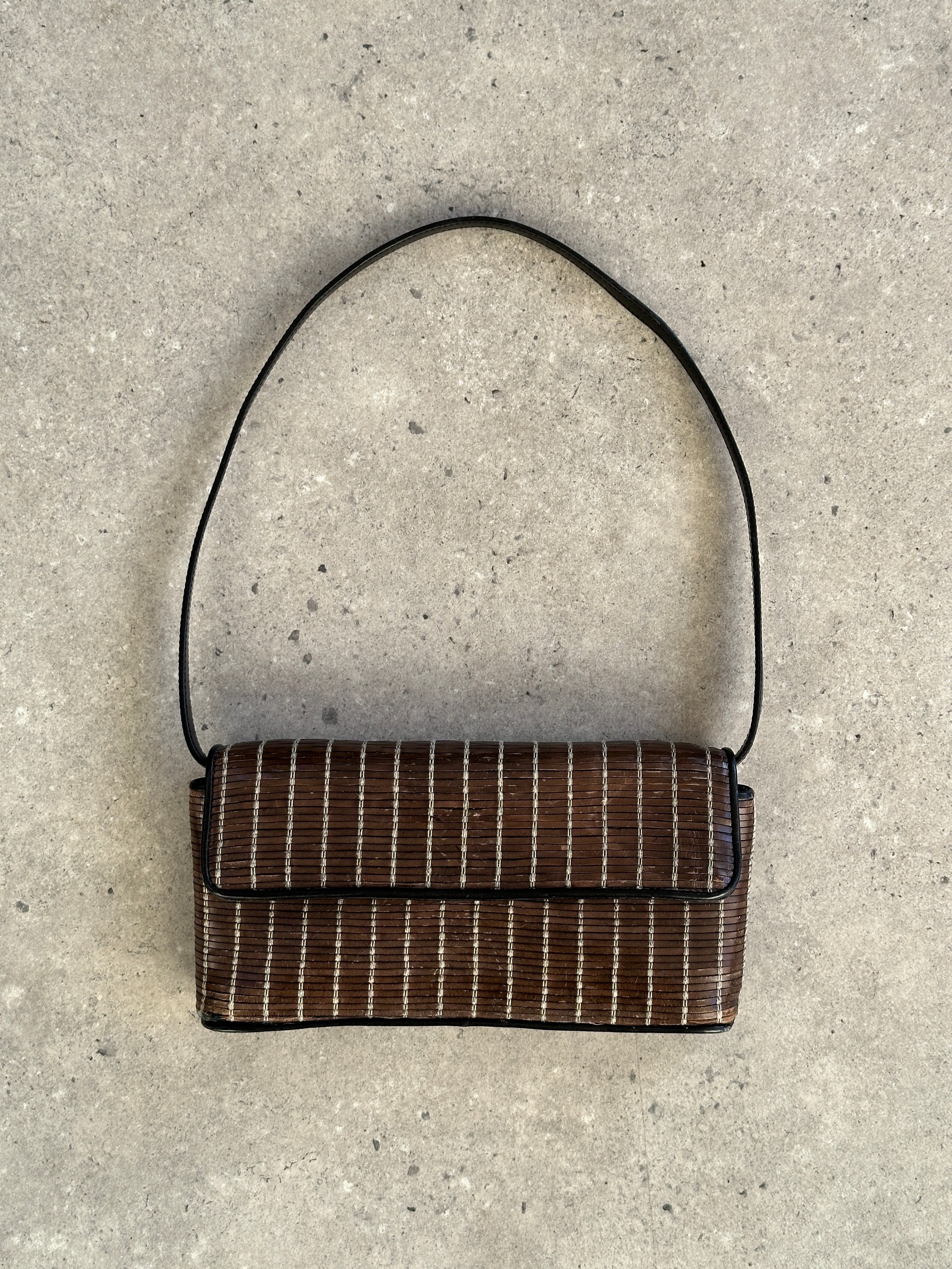 Giorgio Armani leather handbag with elegant design, featuring sleek craftsmanship and high-quality brown leather.