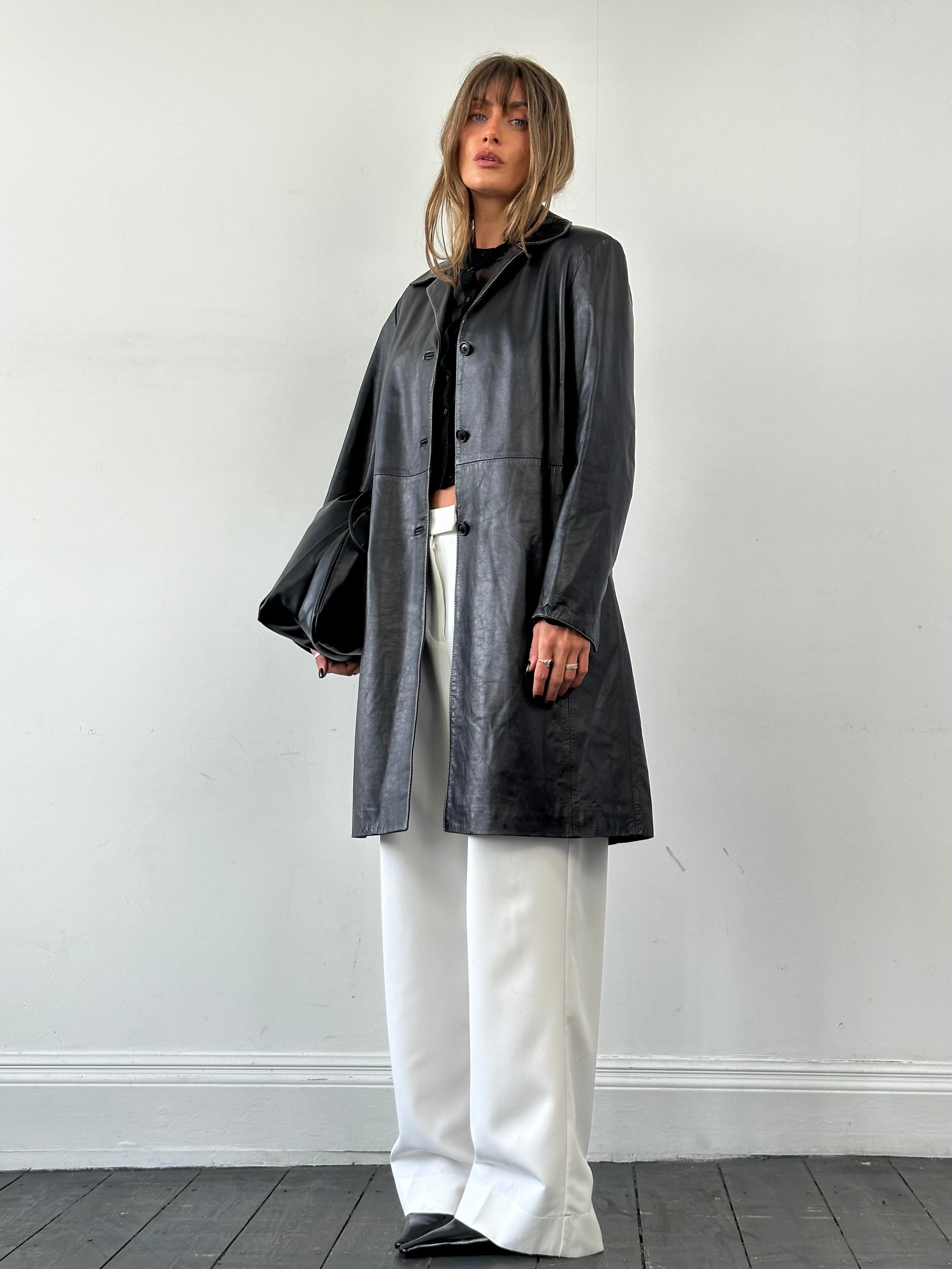 Conbipel contrast stitch leather trench coat jacket in black, featuring stylish detailing and a classic silhouette.
