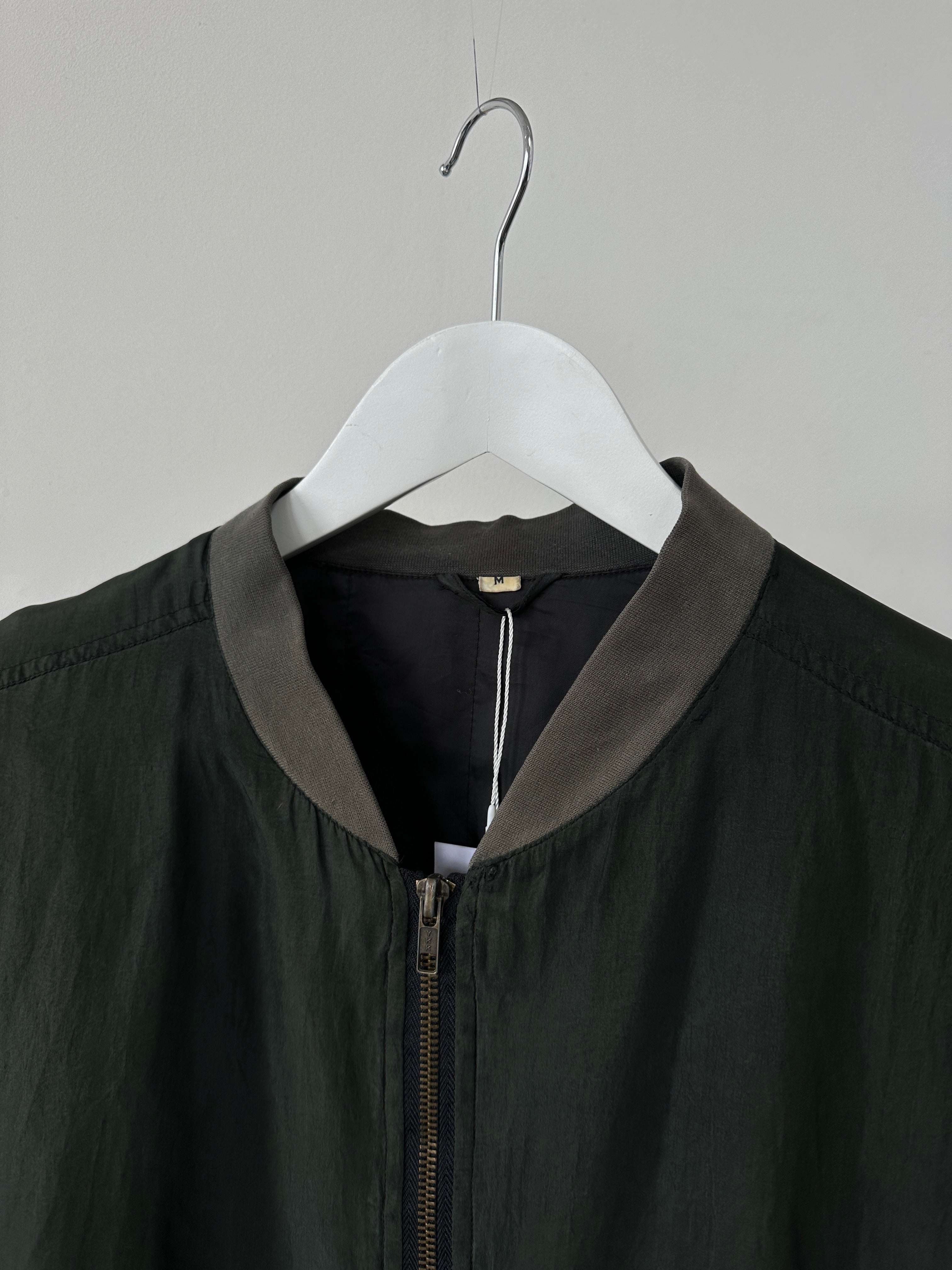 Vintage pure silk bomber jacket in size L, featuring a classic design with a smooth, shiny silk finish and ribbed collar and cuffs.