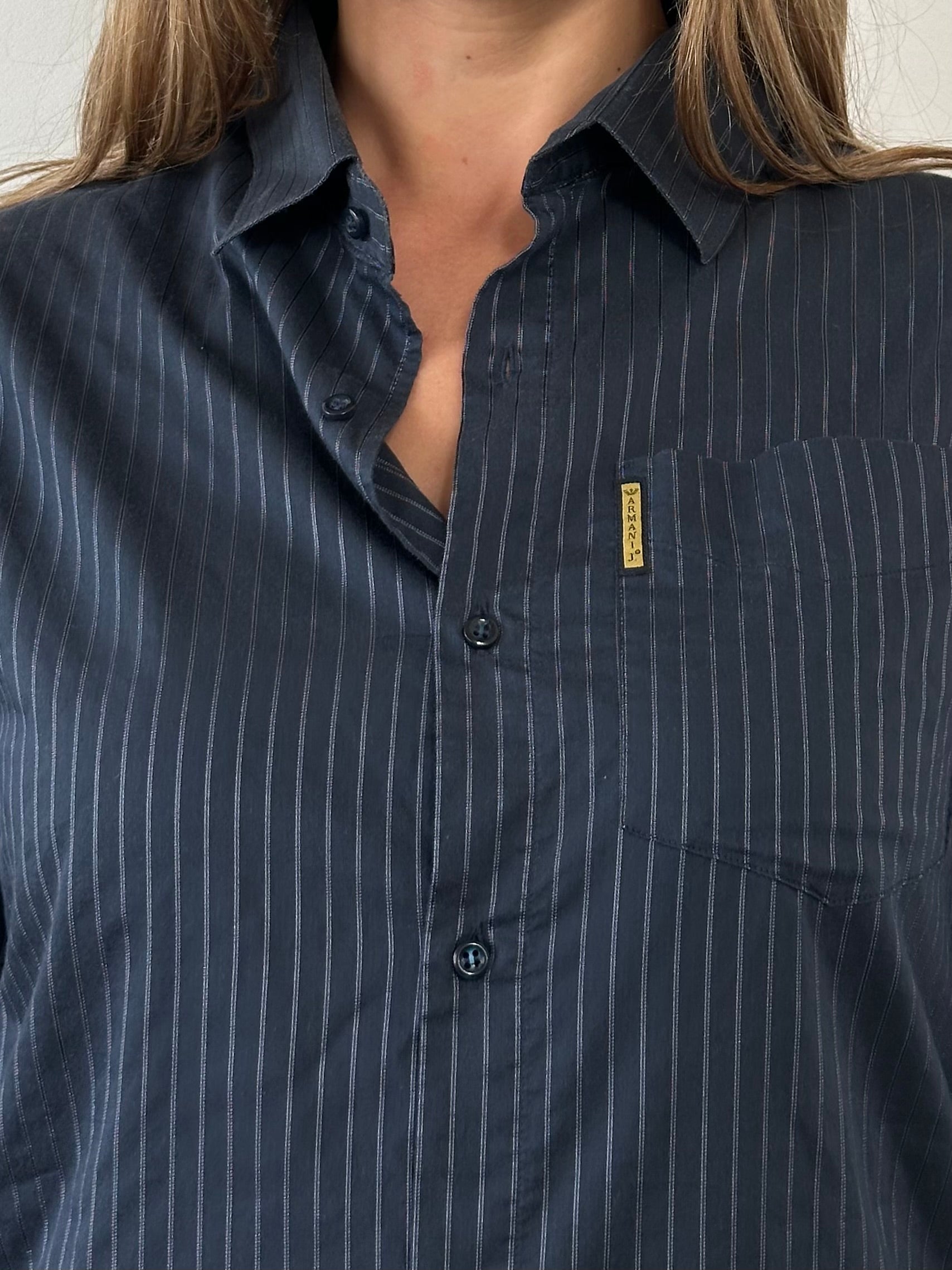 Armani Jeans men's stripe cotton logo shirt displayed on a hanger, featuring bold stripes and the Armani logo.