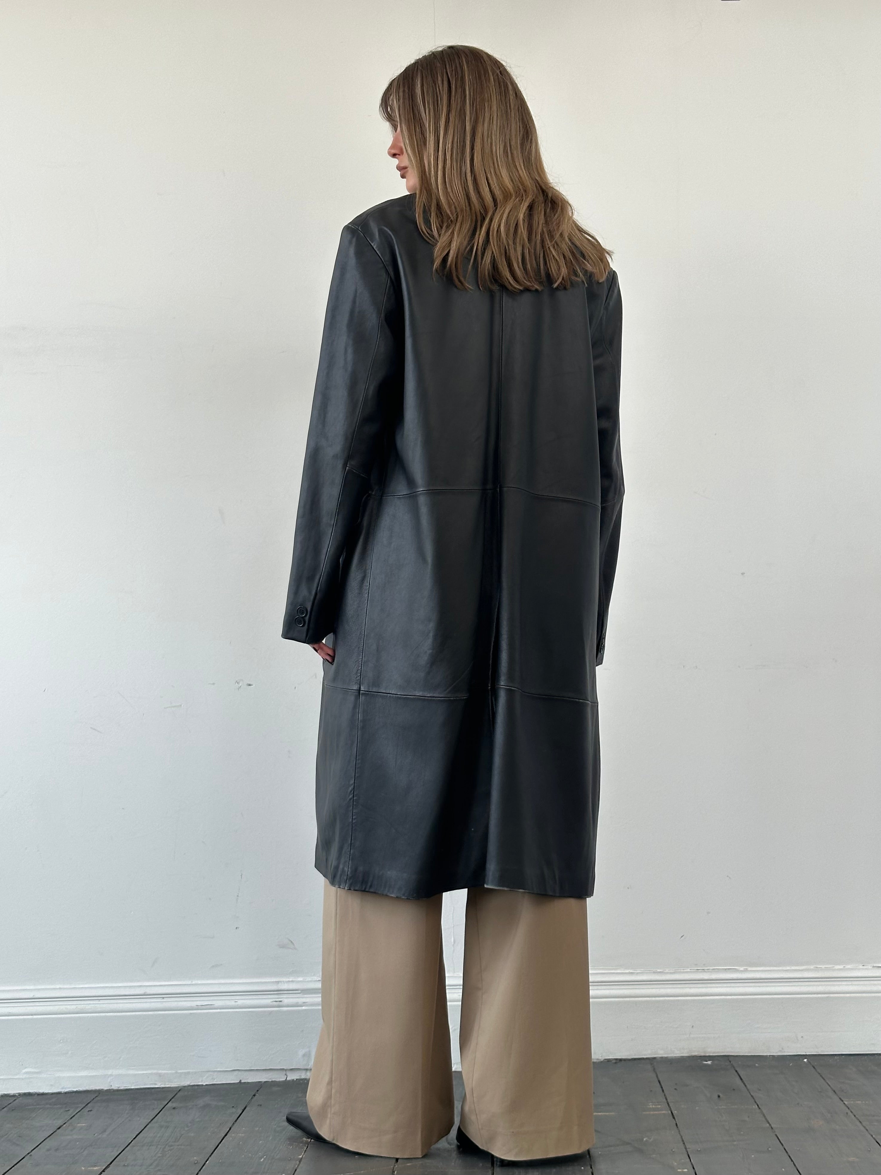 Vintage leather trench coat in XL size, stylish leather jacket with classic design and detailed stitching, displayed on a hanger.