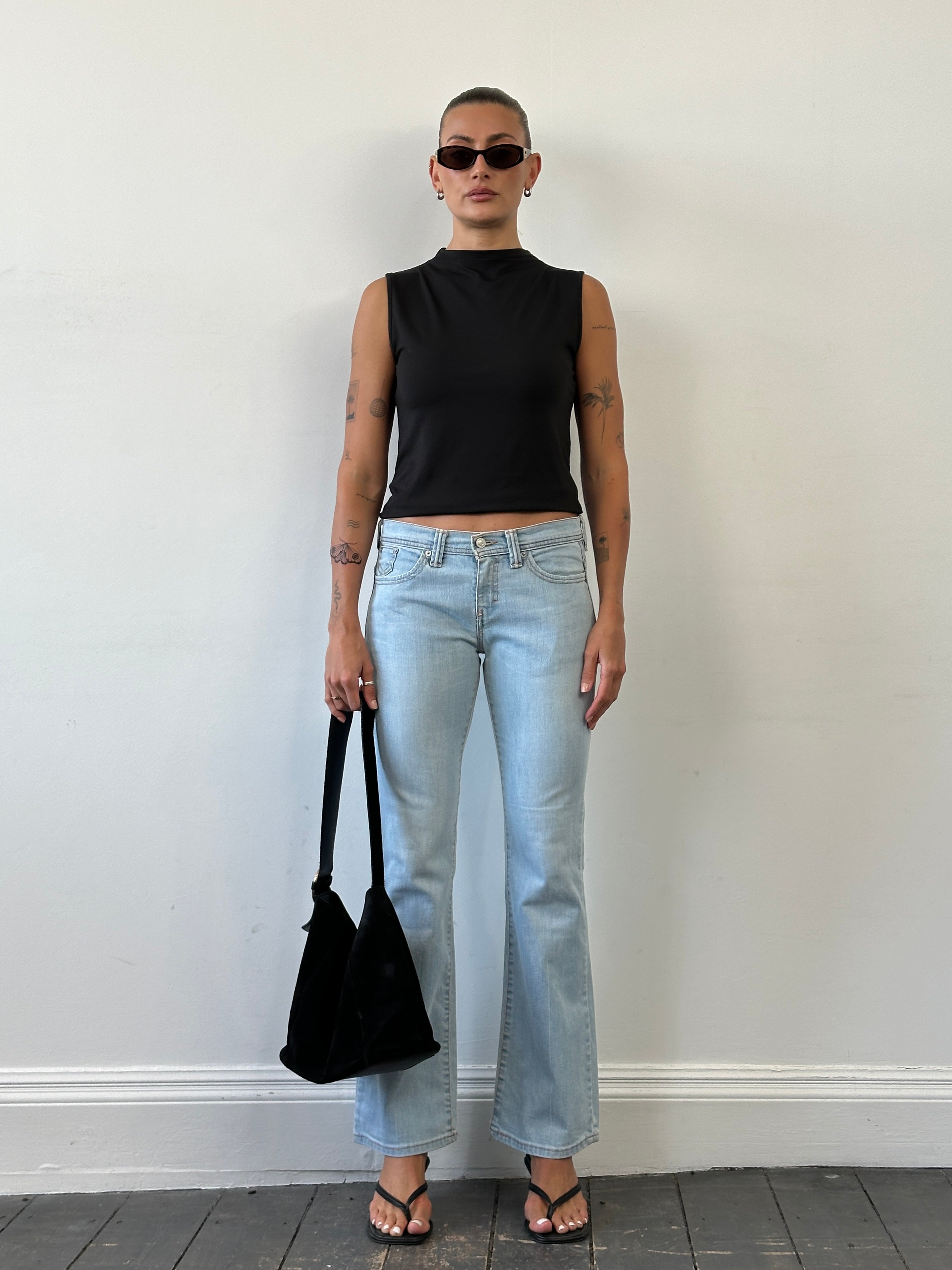 Levi’s low waist flared denim jeans in size W28, showcasing classic blue denim with a fitted waist and flared leg design.