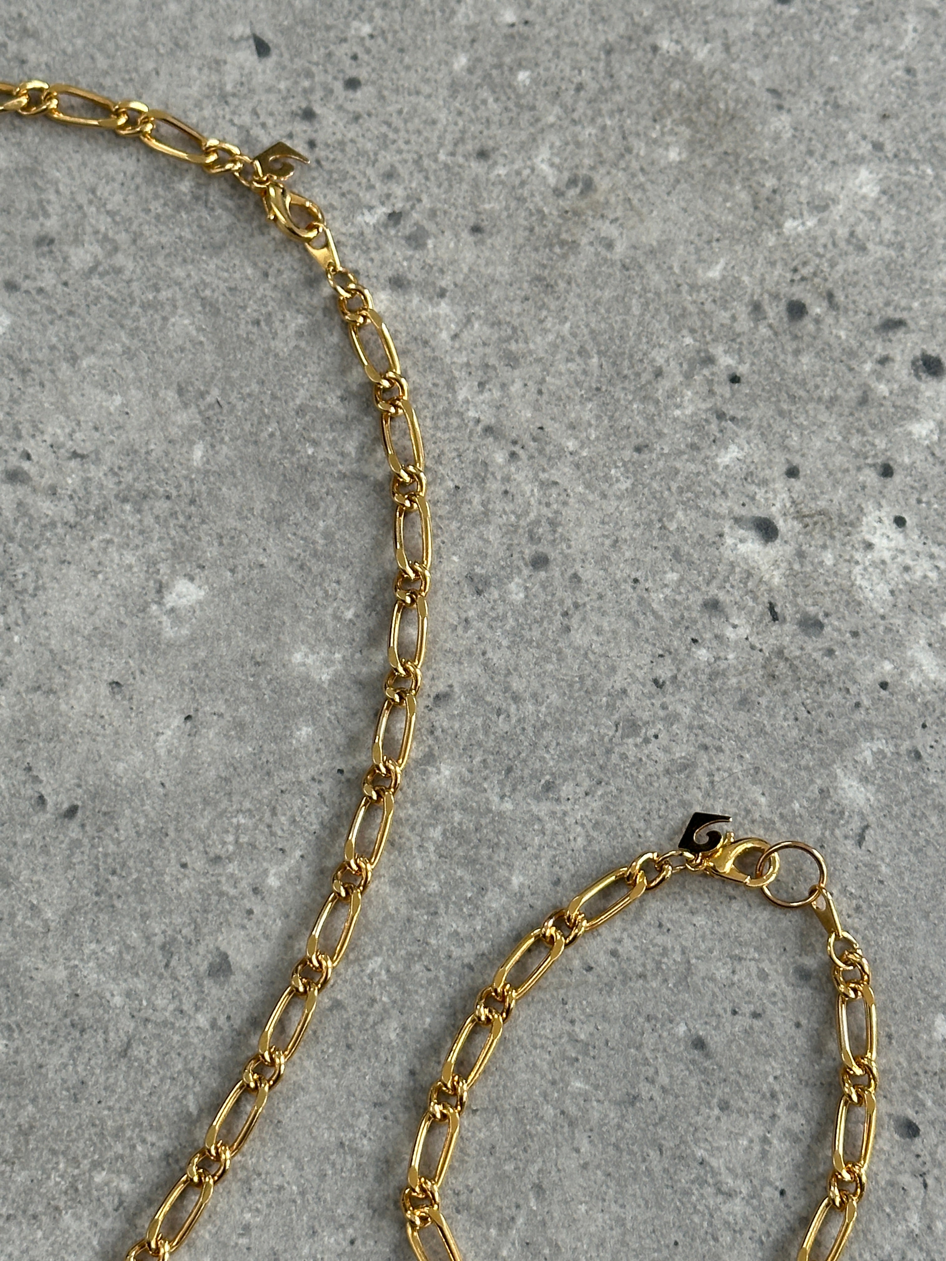 Pierre Cardin gold plated necklace and bracelet chain set featuring sleek, elegant jewelry with polished links.