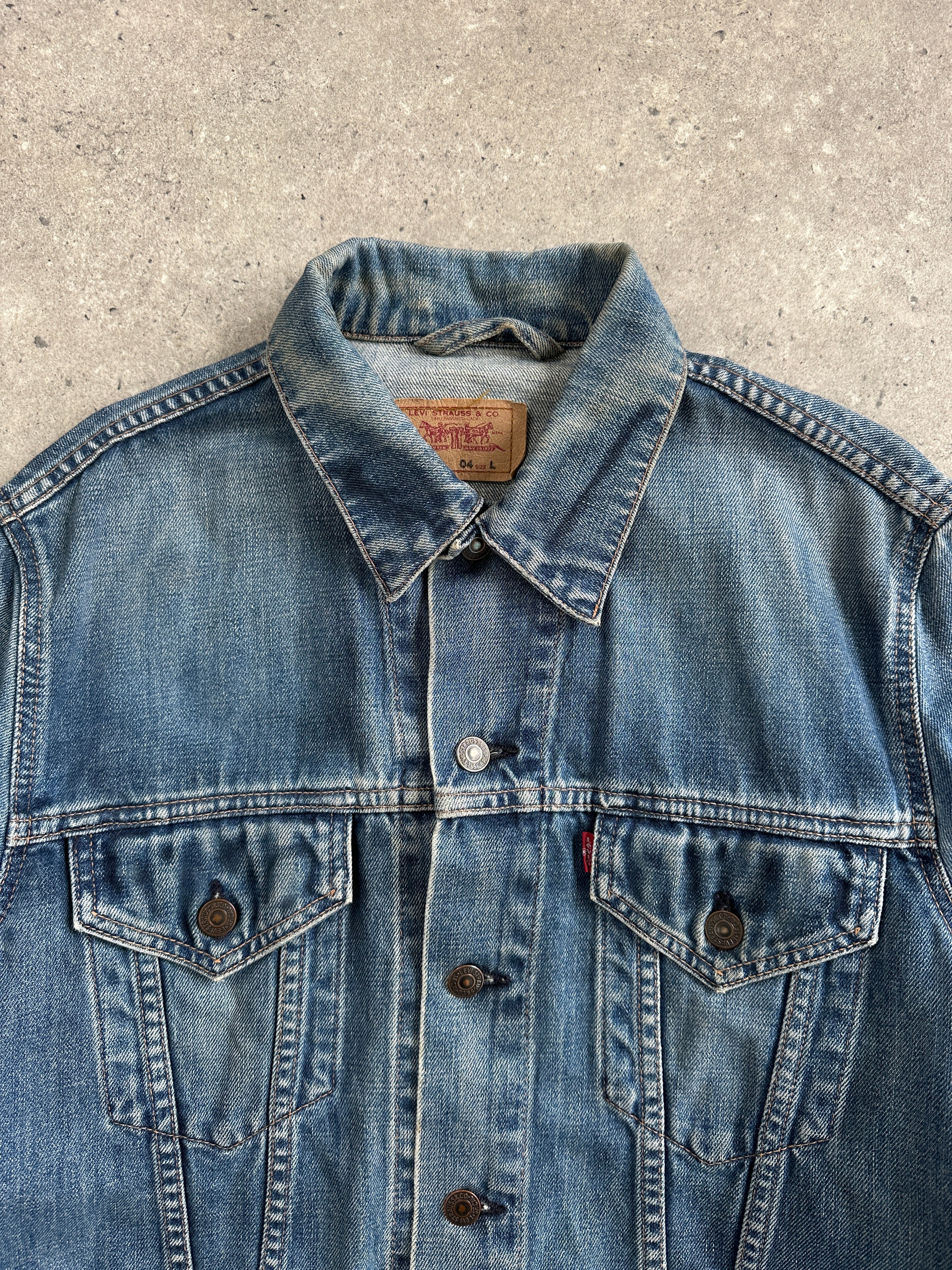 Levi’s 1990s faded denim jacket, medium size, featuring classic design with distressed light blue denim and button front.