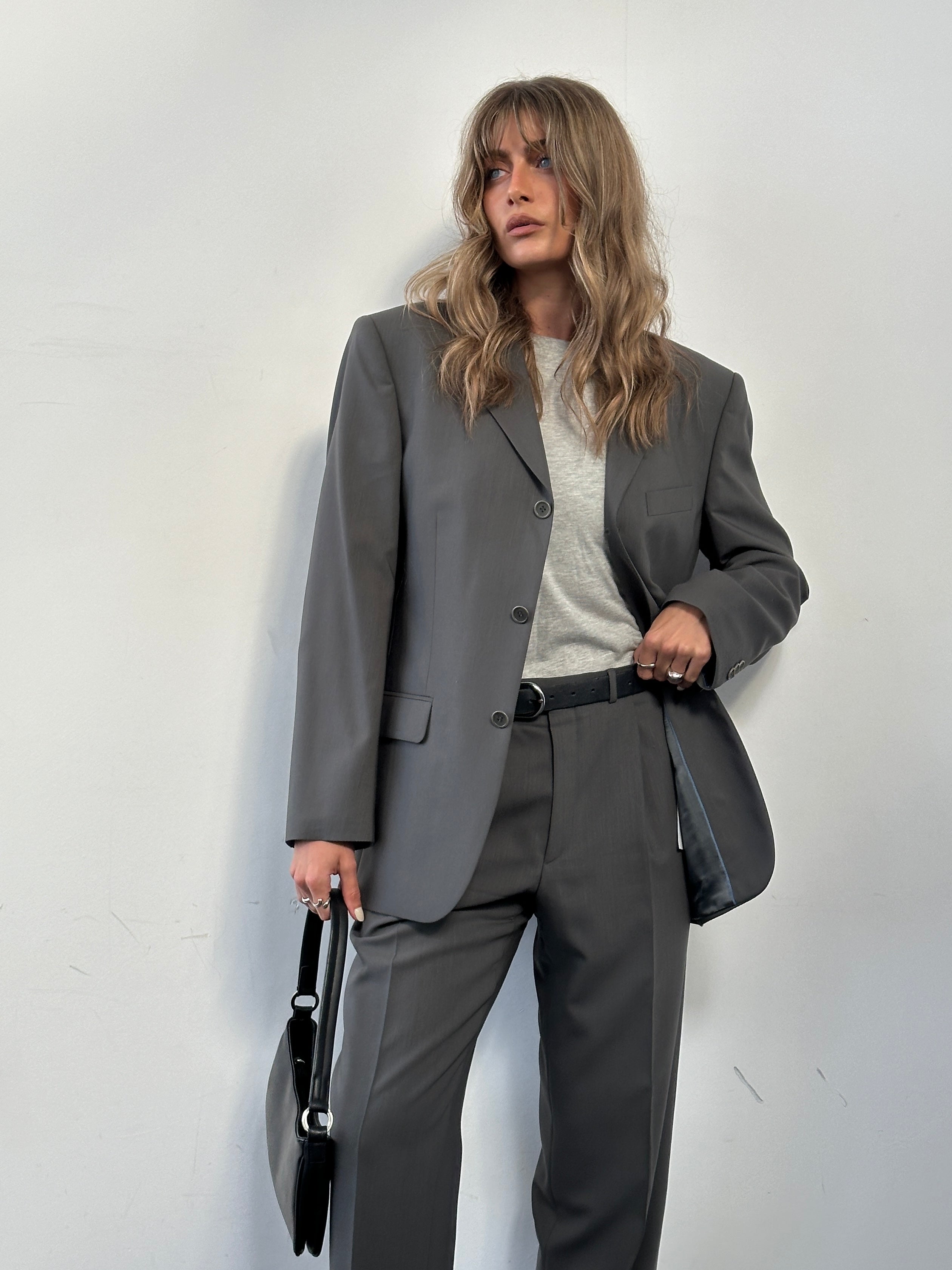 Balmain pure wool single-breasted jumpsuit in size 38S/W32, displayed on a hanger with details of fabric and tailoring.