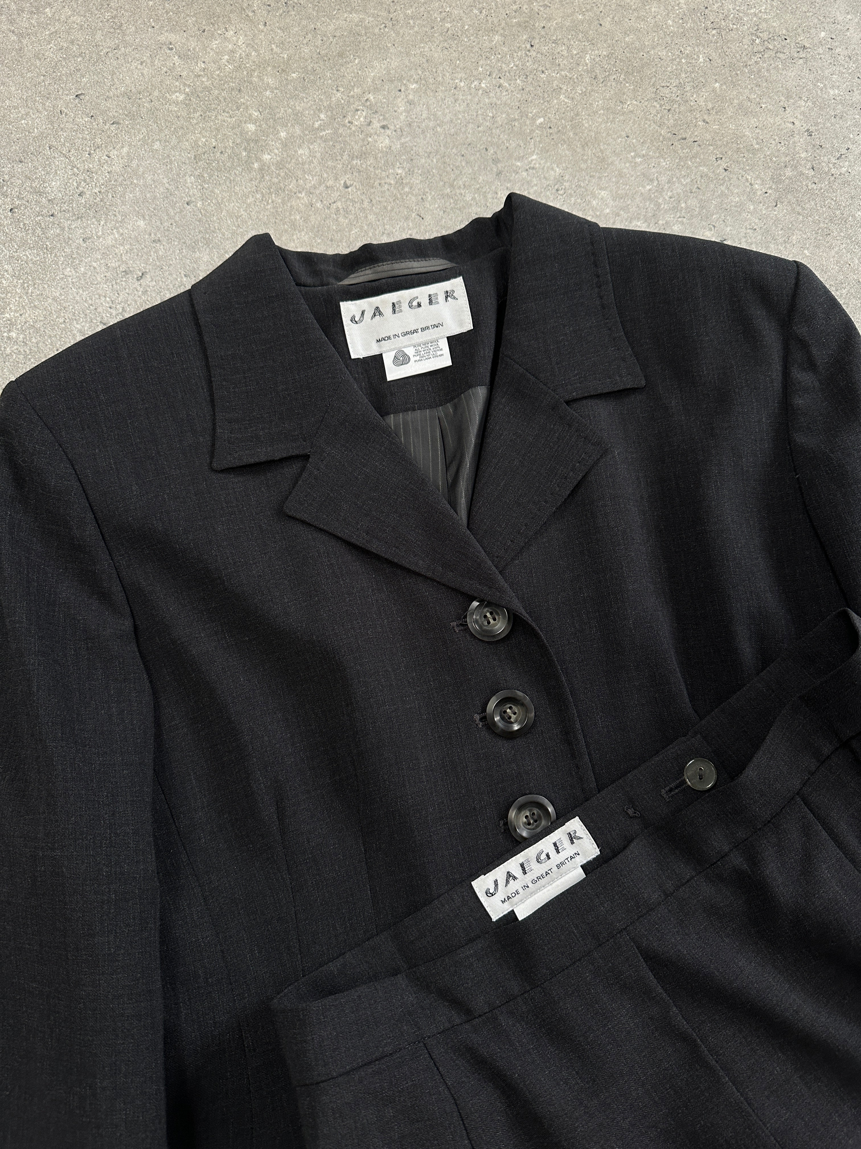 Jaeger 1990s pure wool two-piece skirt suit, black with fitted blazer and pencil skirt, vintage 90s women's fashion.