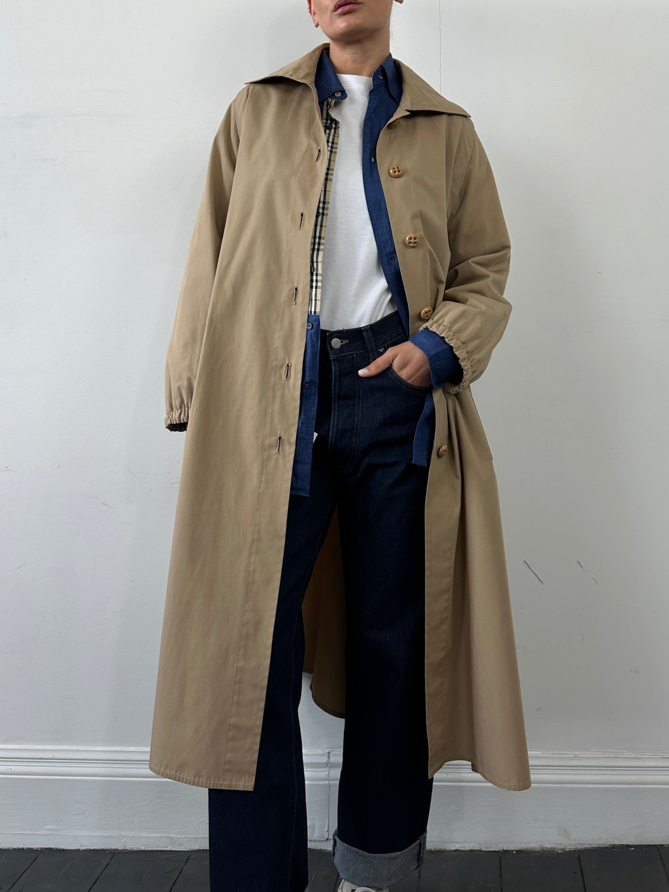 Vintage brand vintage cotton A-line single-breasted trench coat in size M displayed on a hanger.