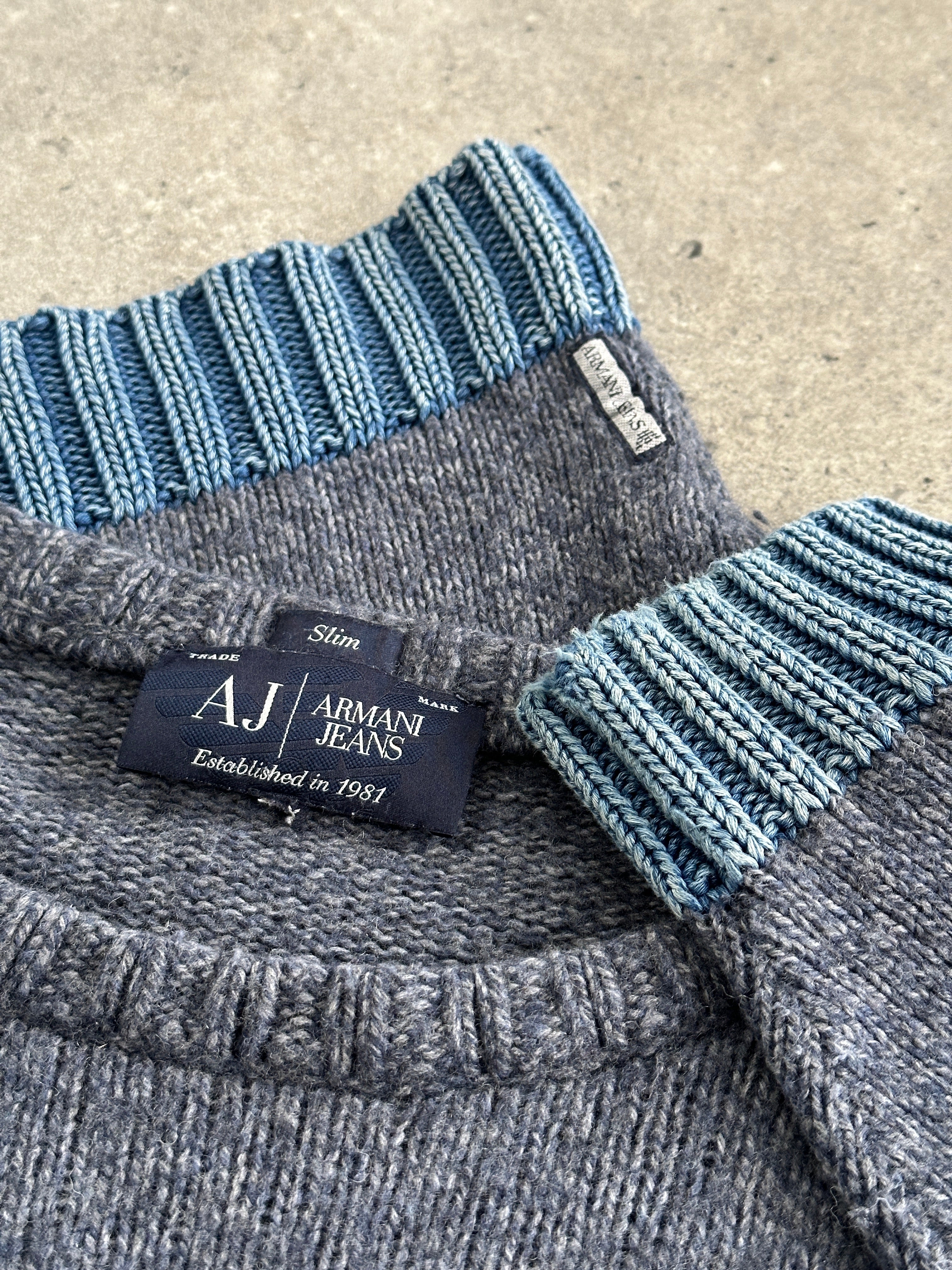 Armani Jeans wool knitted jumper in navy and gray, featuring a crew neck and ribbed cuffs, size M/L, displayed on a hanger.