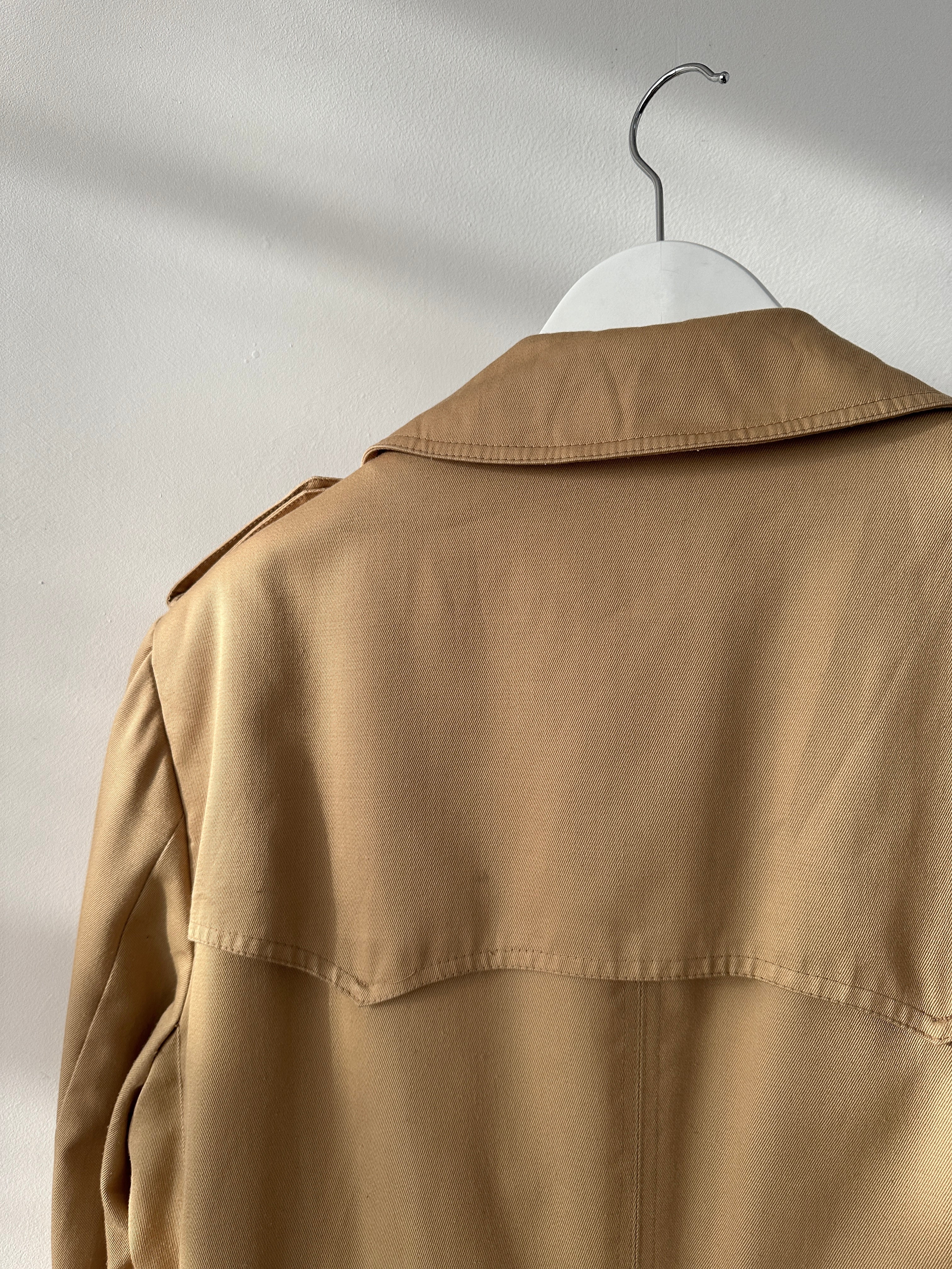 Christian Dior cotton double-breasted trench coat in size L/XL, shown hanging with classic collar and button details.
