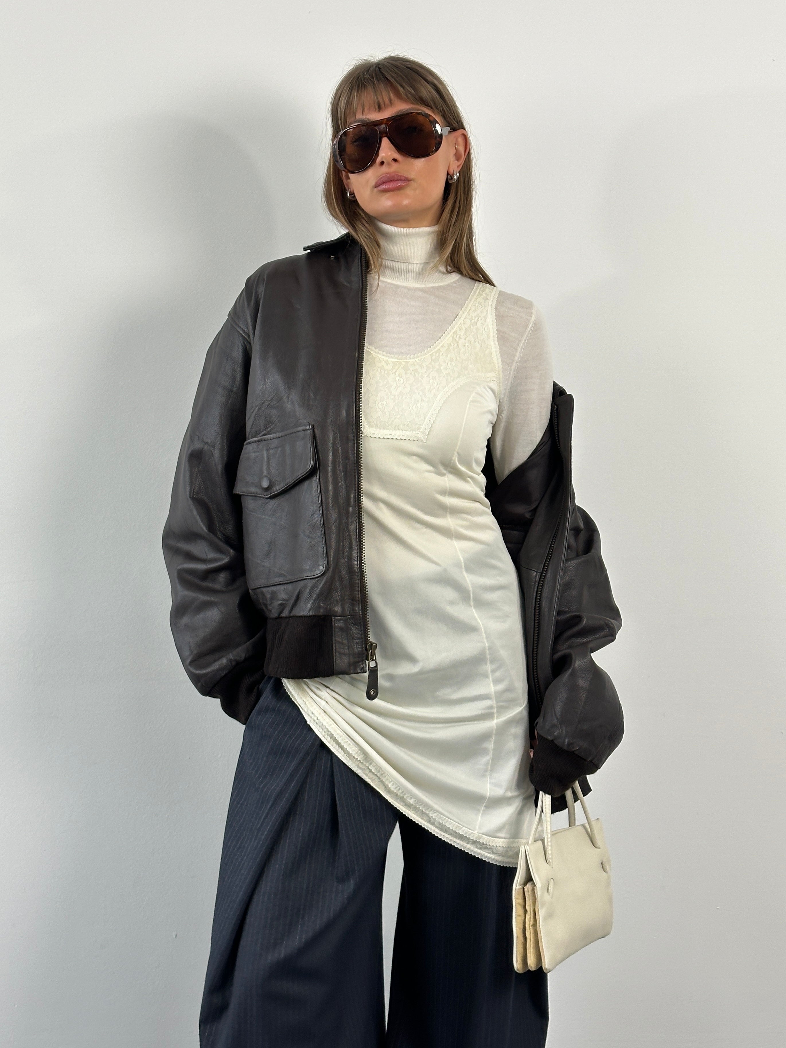 Vintage 1990s XL leather bomber jacket with concealed placket, showcasing classic vintage style and high-quality leather.