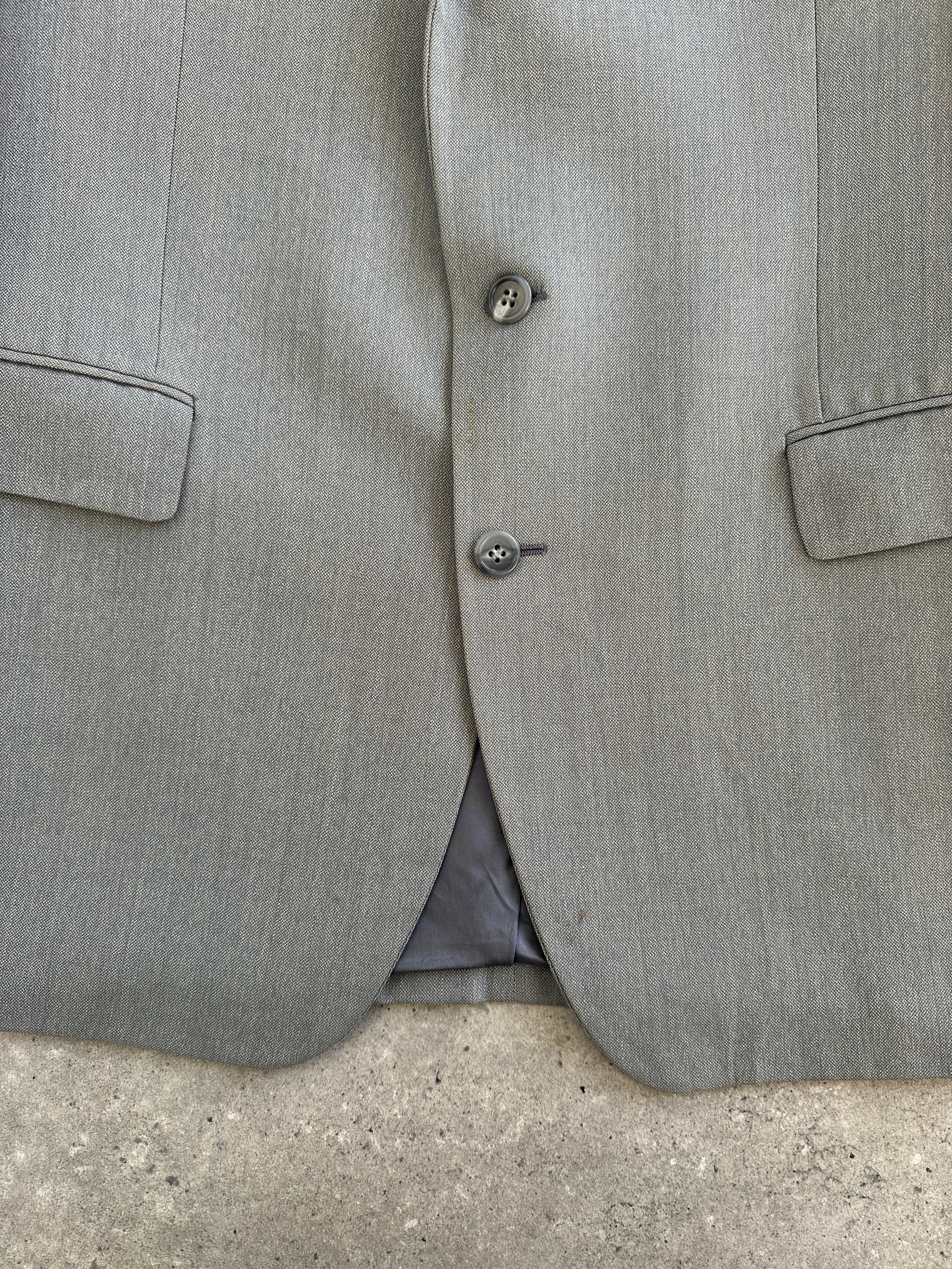 Yves Saint Laurent 1990s pure wool single-breasted blazer in size 40R/L, tailored fit, classic design, dark color, detailed stitching.