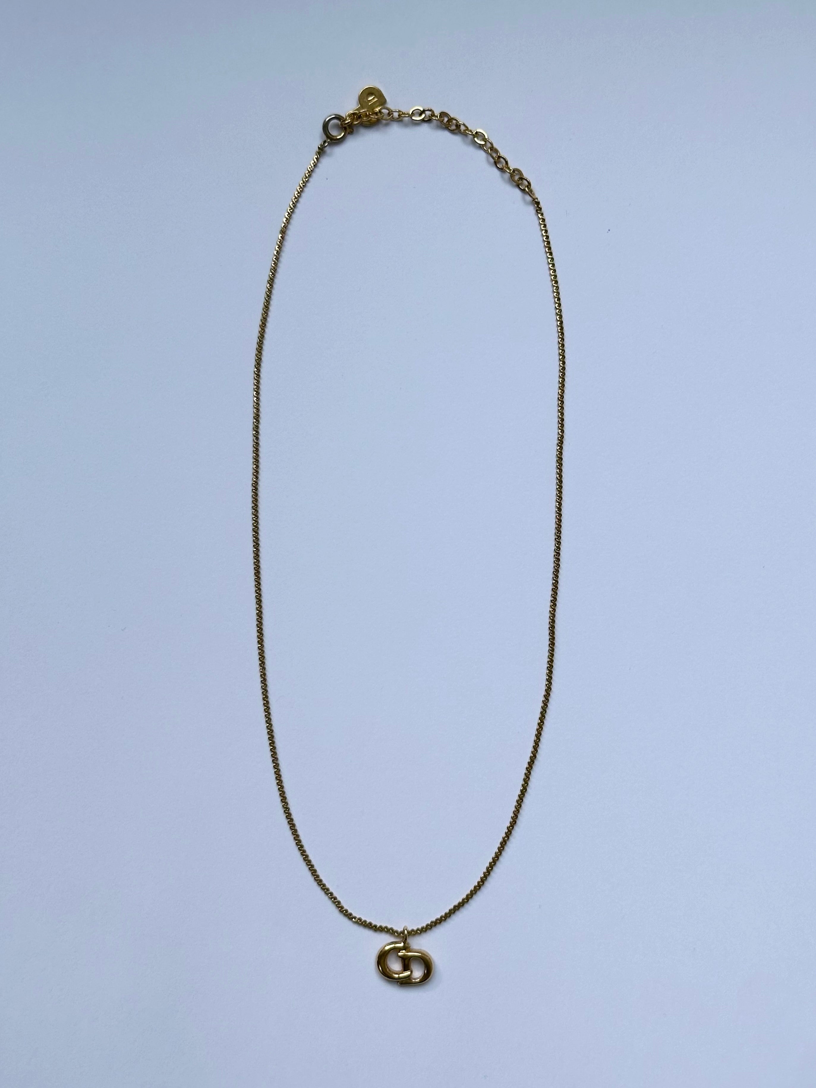 Christian Dior 16-inch gold-plated logo pendant necklace, featuring a stylish chain and iconic Dior emblem.