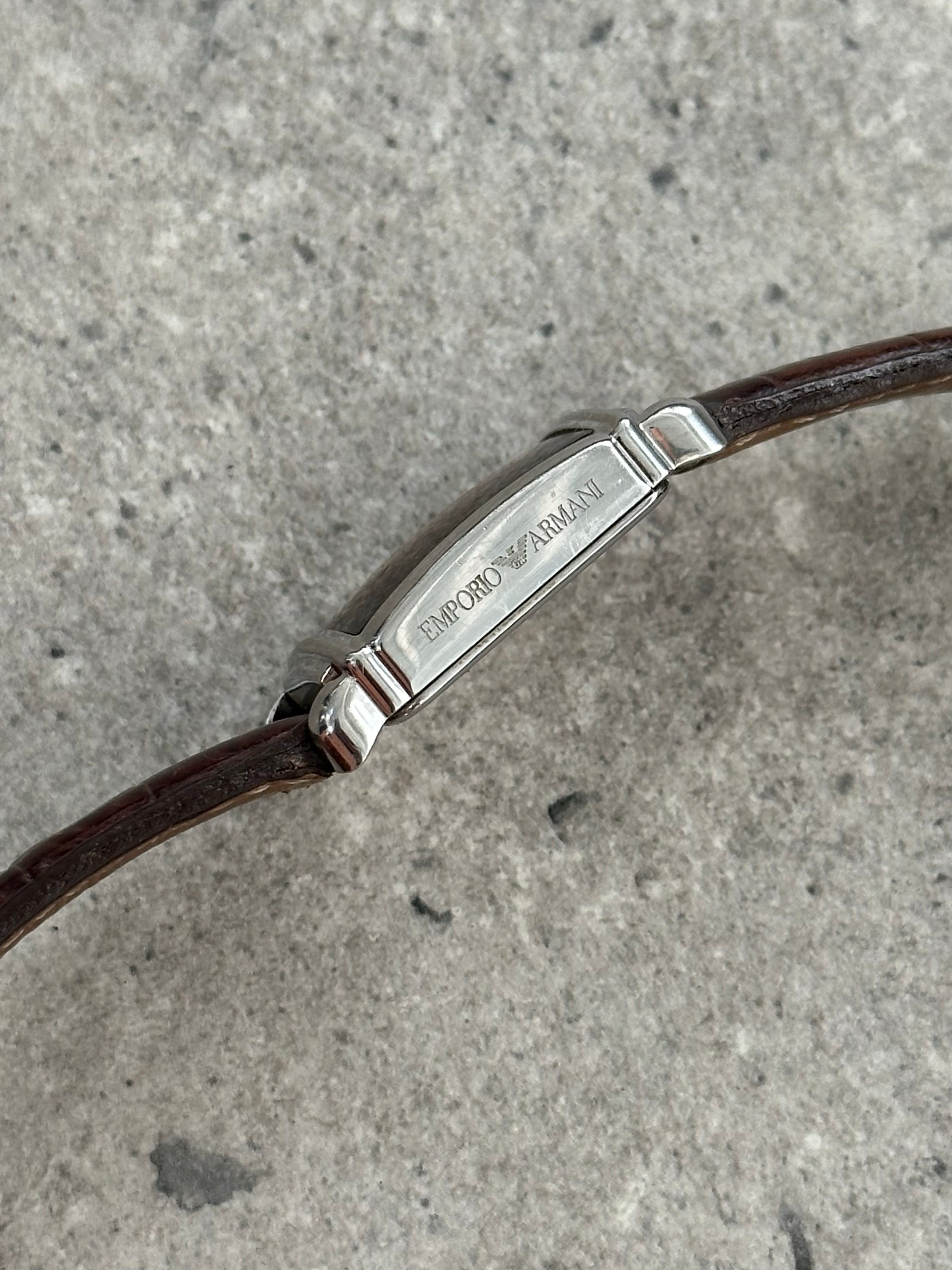 Emporio Armani 2000s leather logo watch with black dial and silver case, featuring the Armani logo on the strap and face.