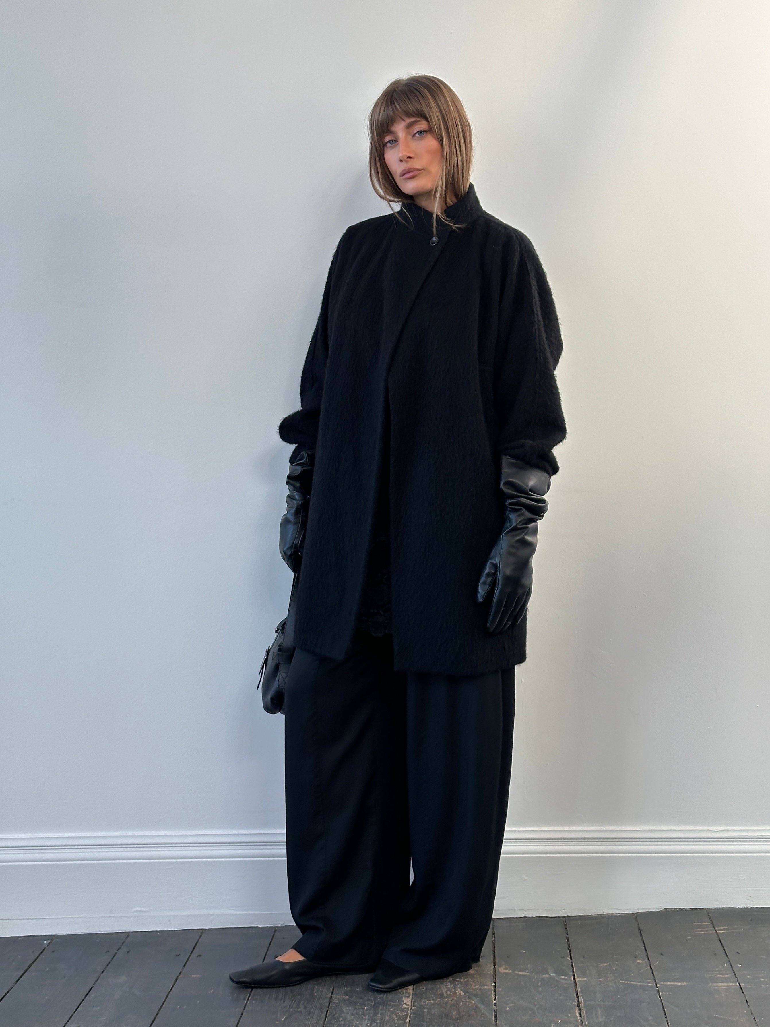 Vintage 1990s wool mohair high neck coat in size M, featuring a classic high collar and textured fabric, displayed on a hanger.