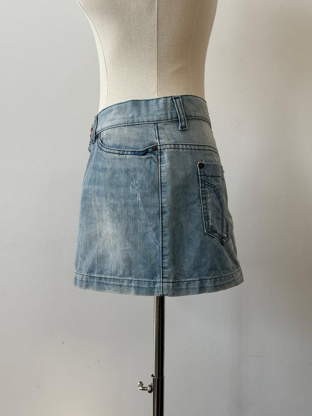 Miss Sixty 2000s denim mini skirt in W30, showing classic high-waisted style with distressed details and a button front.