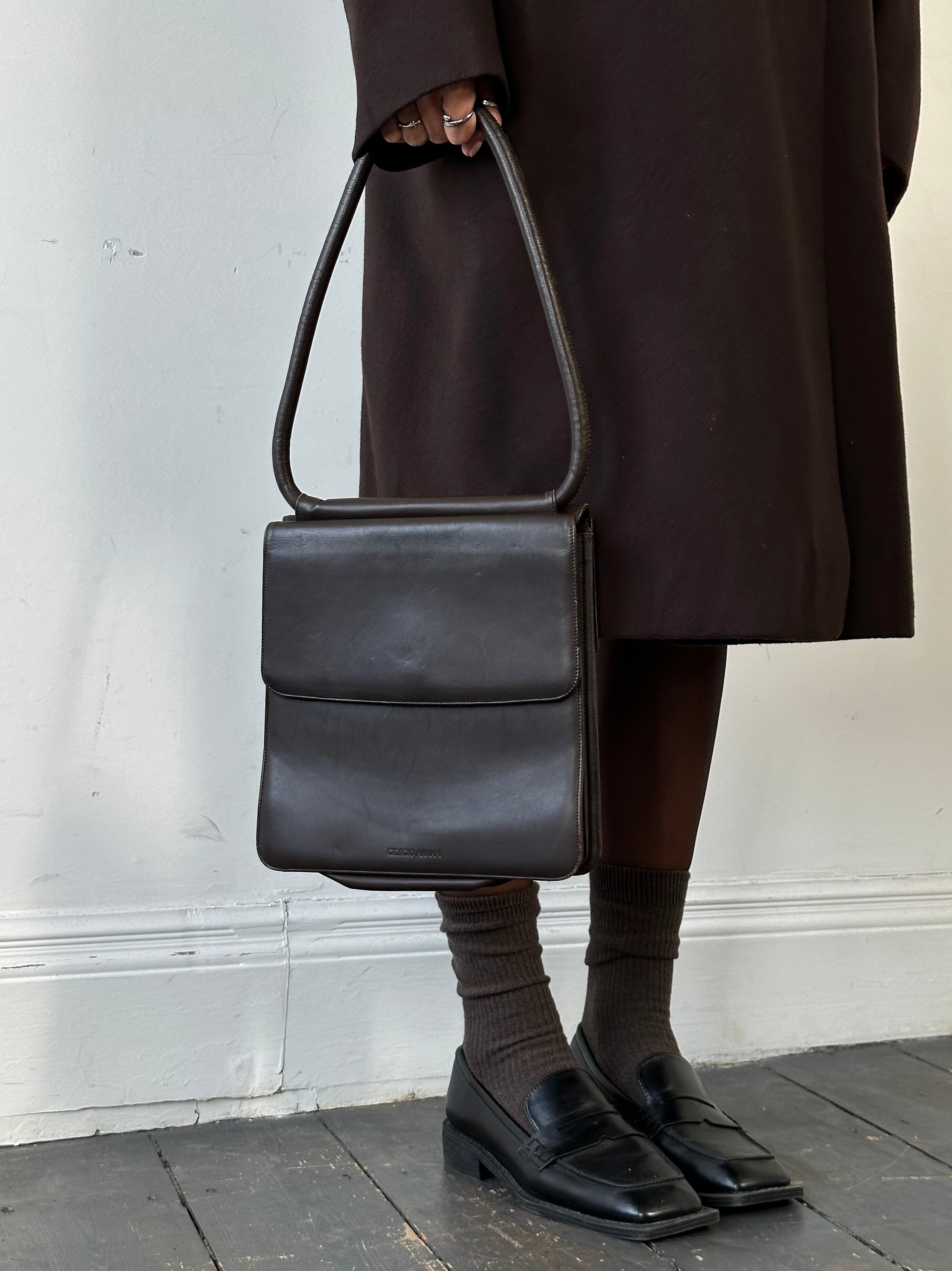 Giorgio Armani Le Collezioni leather shoulder bag with sleek design, top handle, and subtle branding on smooth leather surface.