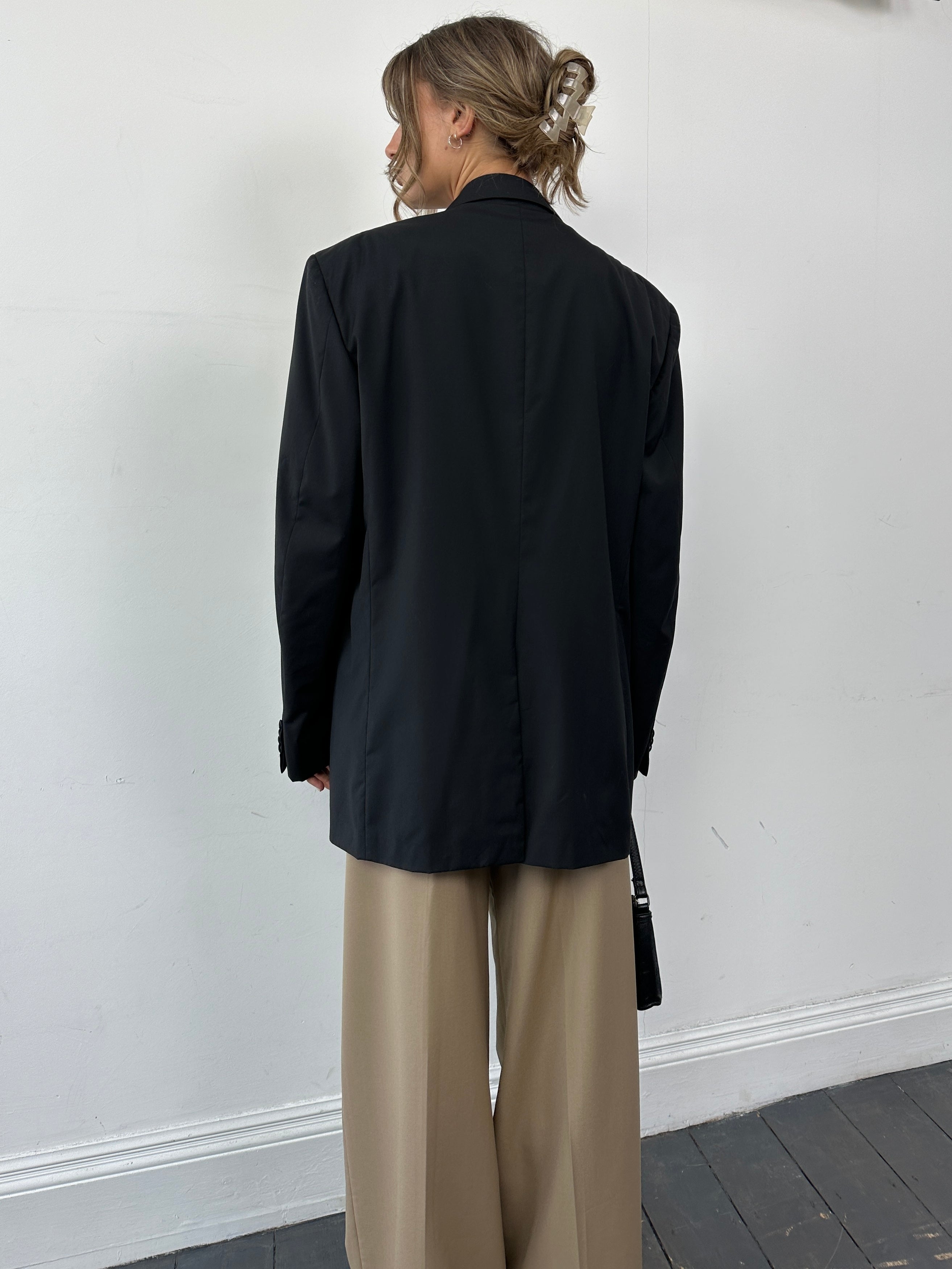 Givenchy tuxedo blazer in pure wool, single-breasted design, size XL, displayed on a hanger with a classic lapel and tailored fit.