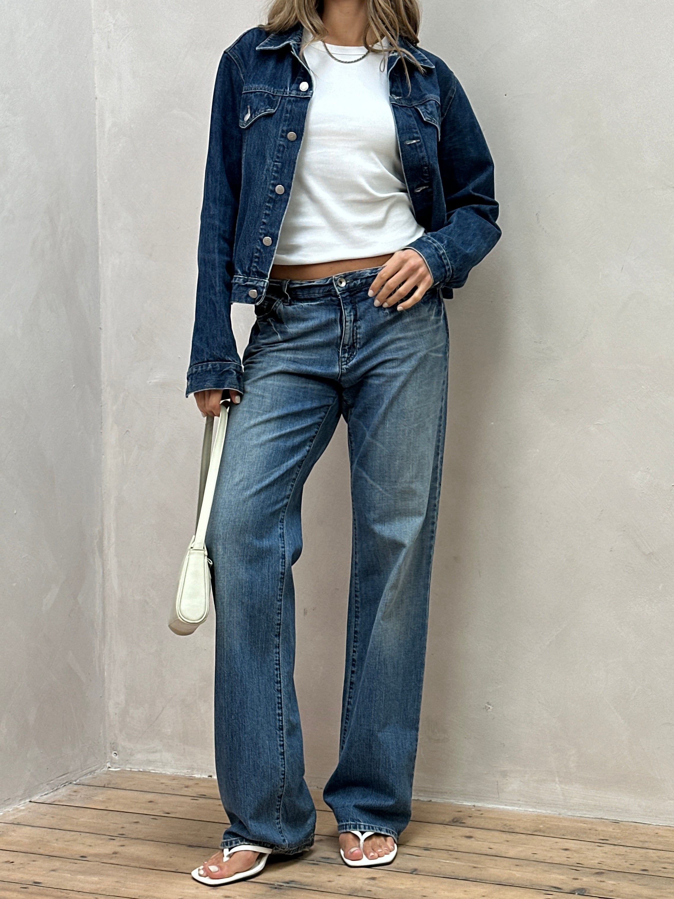 Armani Jeans stonewashed mid waist denim jeans in size W34, featuring classic five-pocket design and faded blue wash.