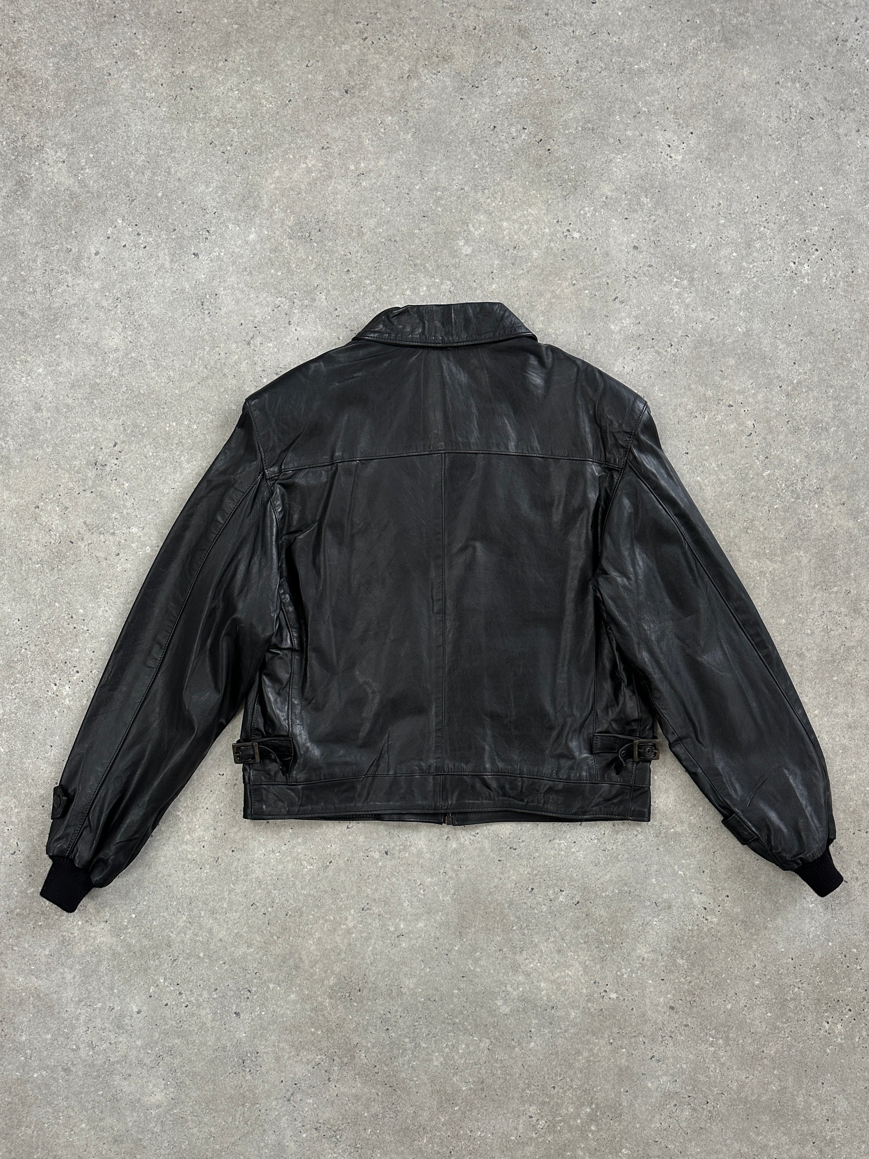 Vintage 1990s boxy cropped leather jacket in black with silver zipper details and wide collar.