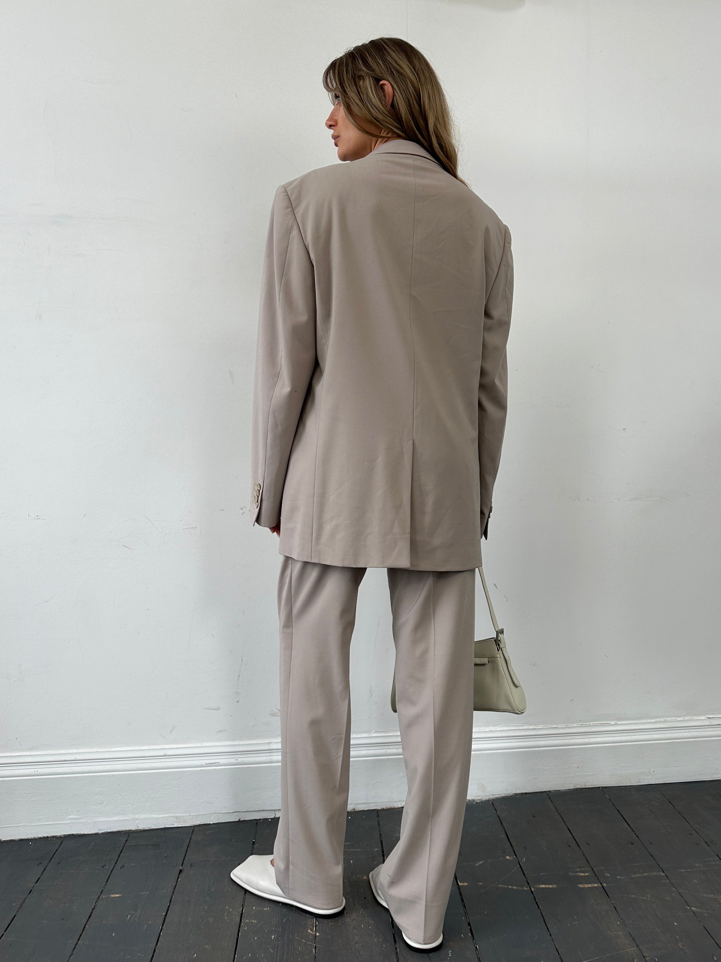 Versace single-breasted wool jumpsuit in size 42R/W30, tailored fit, dark fabric with sleek lapel details, stylish and elegant.