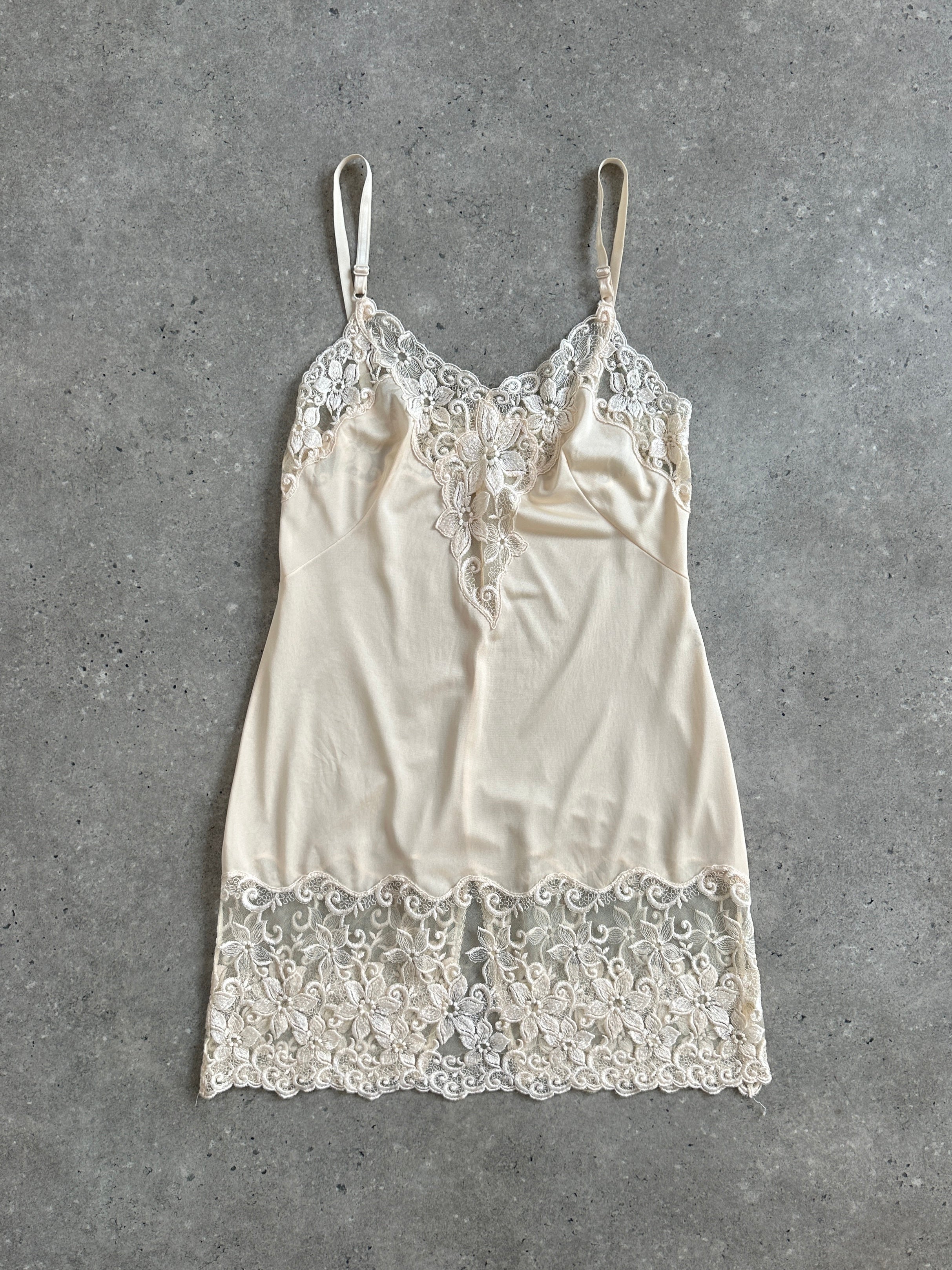Vintage 1990s lace sheer mini slip dress in XS/S, featuring delicate lace fabric and a vintage-inspired design.