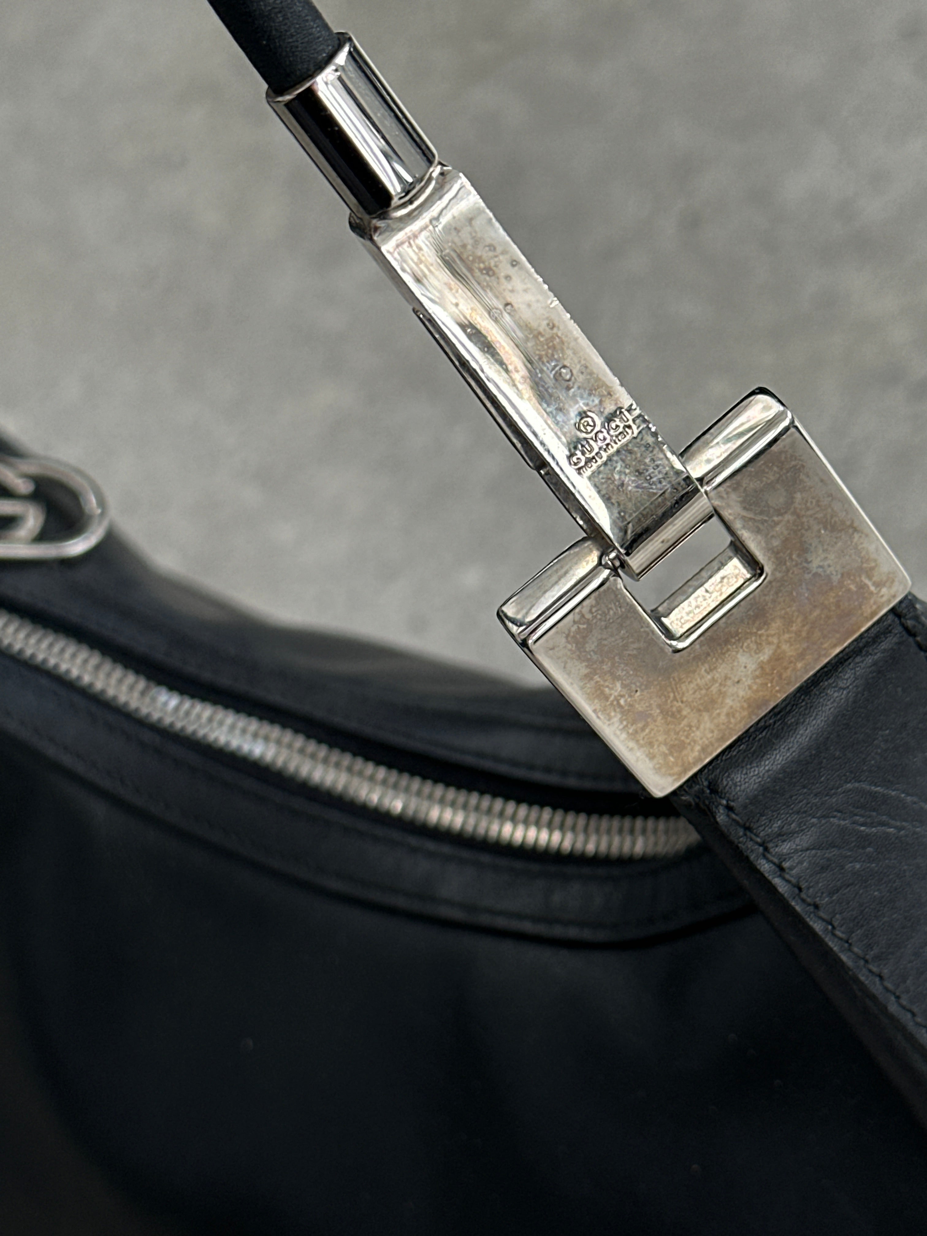 Gucci 1990s Tom Ford GG leather hobo shoulder bag with classic design and spacious interior, featuring signature Gucci monogram.