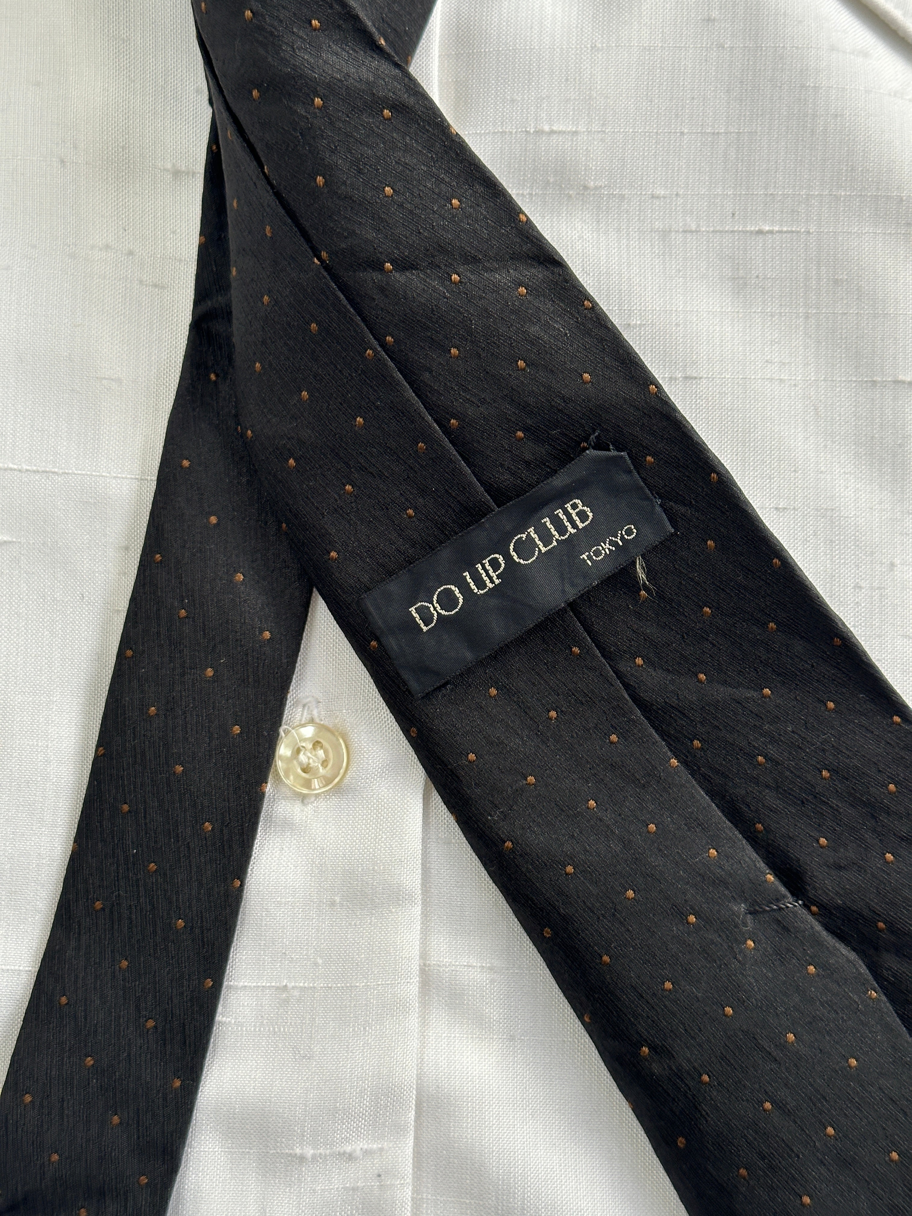 Vintage Japanese 1990s pure silk pin dot tie with classic design, showcasing fine craftsmanship and elegant pattern.