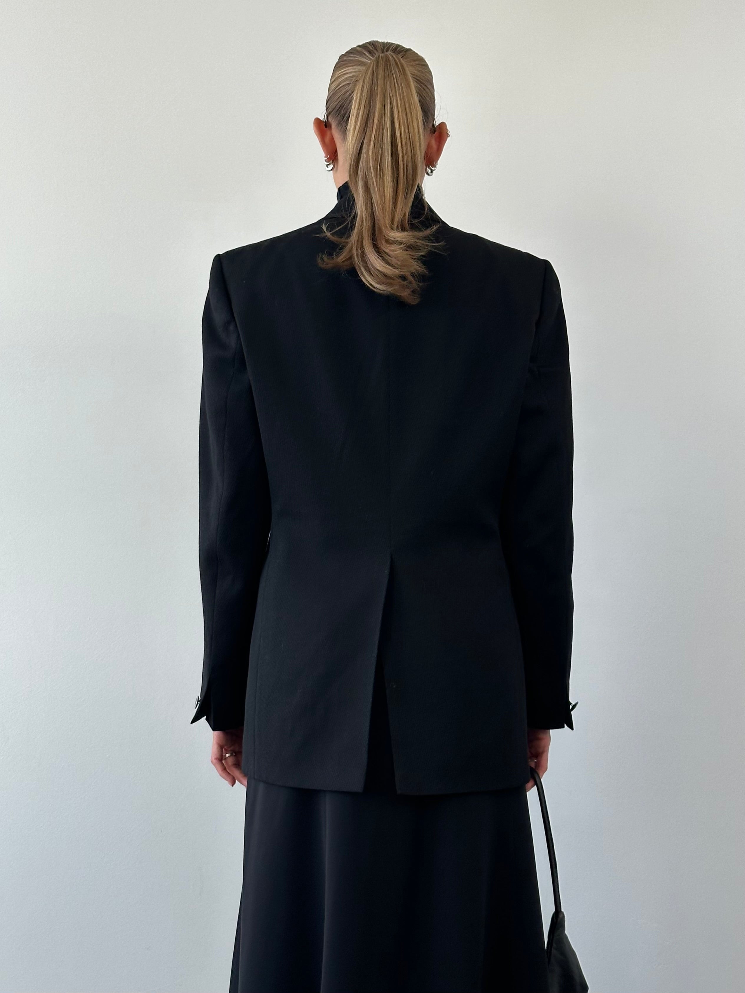 Vintage wool double-breasted blazer in size L, featuring classic design and tailored fit, displayed on a neutral background.