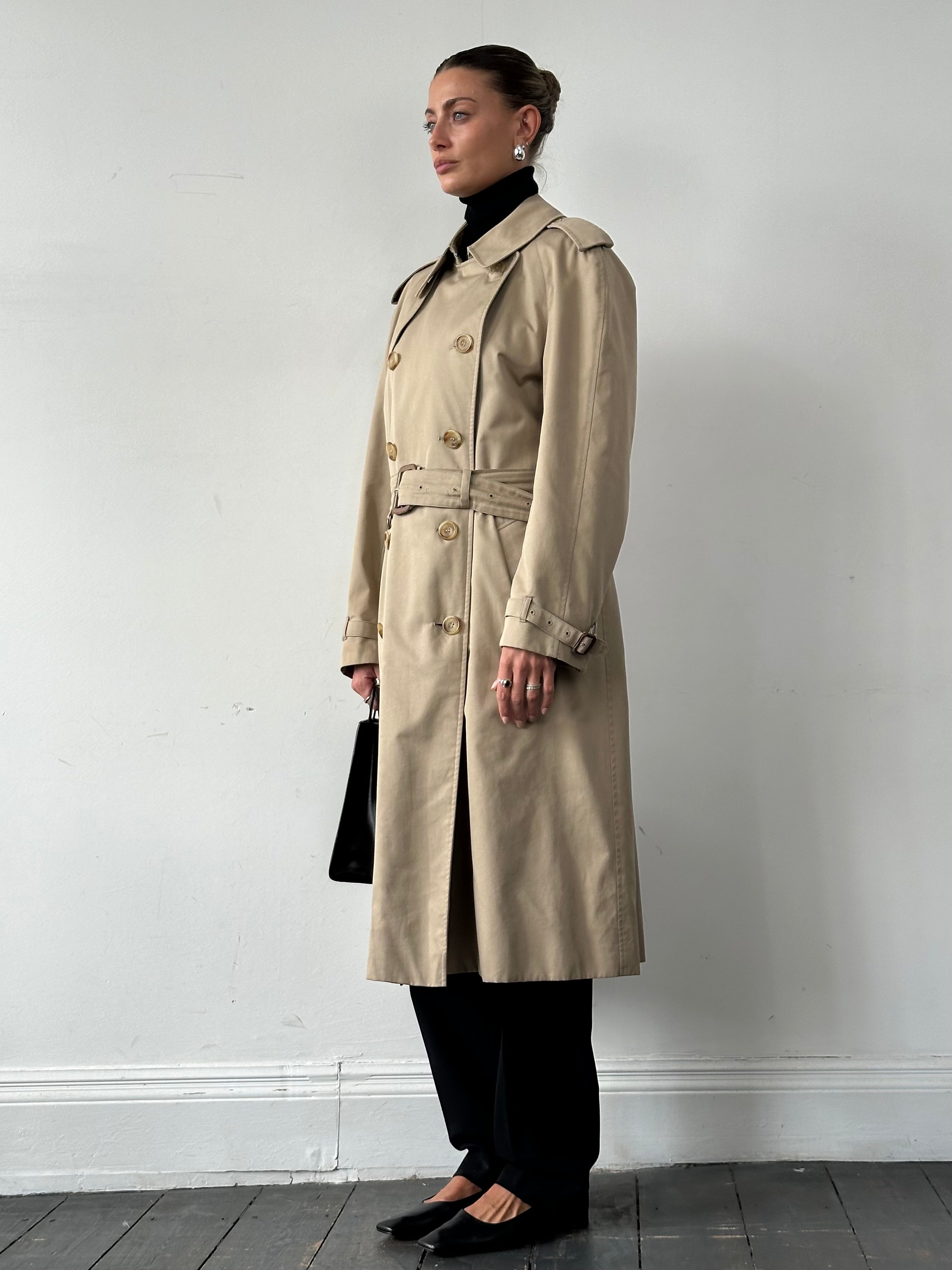 Aquascutum cotton double-breasted belted trench coat in XL, shown on a model, featuring classic design and neutral color.