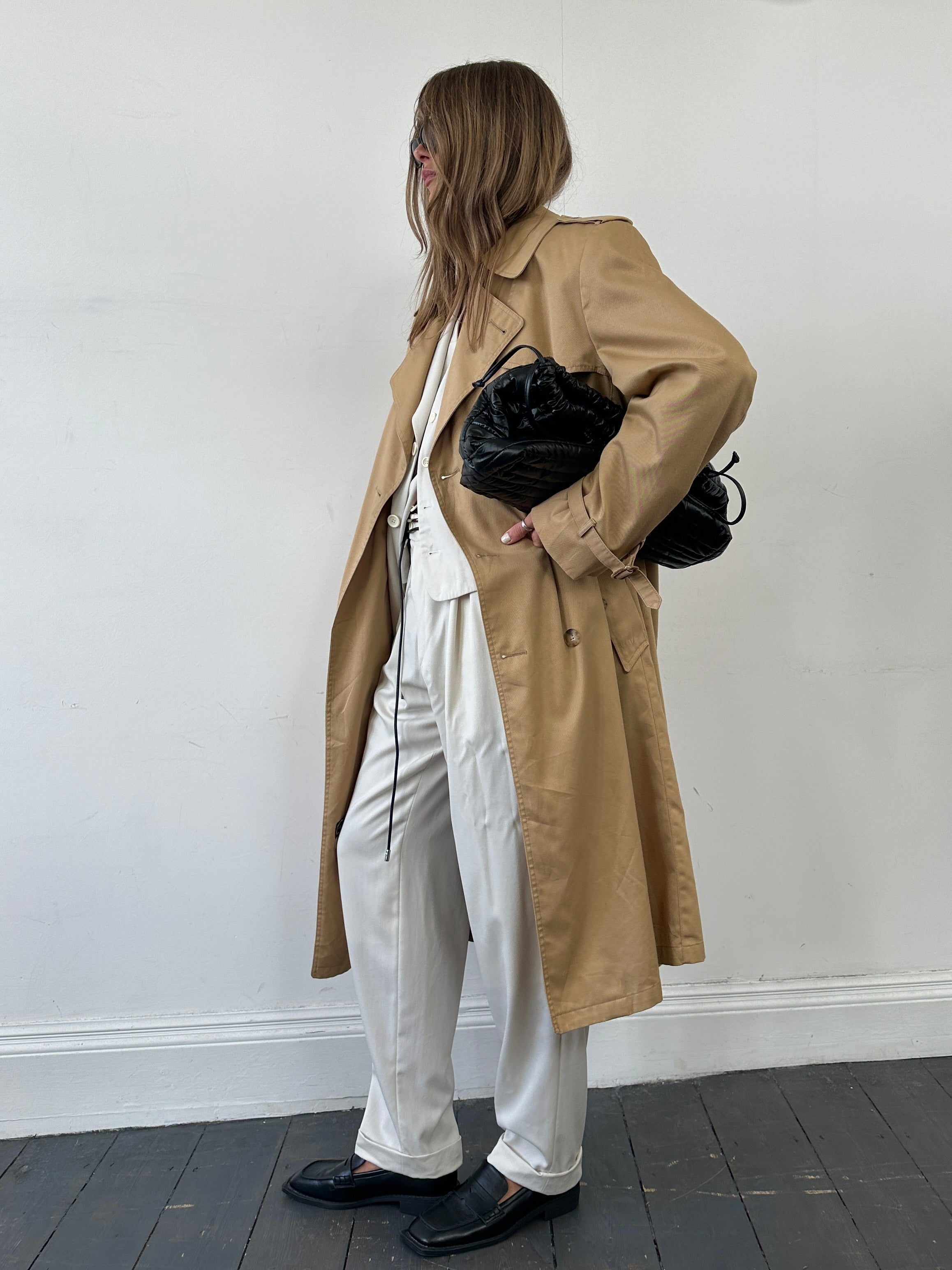 Christian Dior cotton double-breasted trench coat in size L/XL, shown hanging with classic collar and button details.