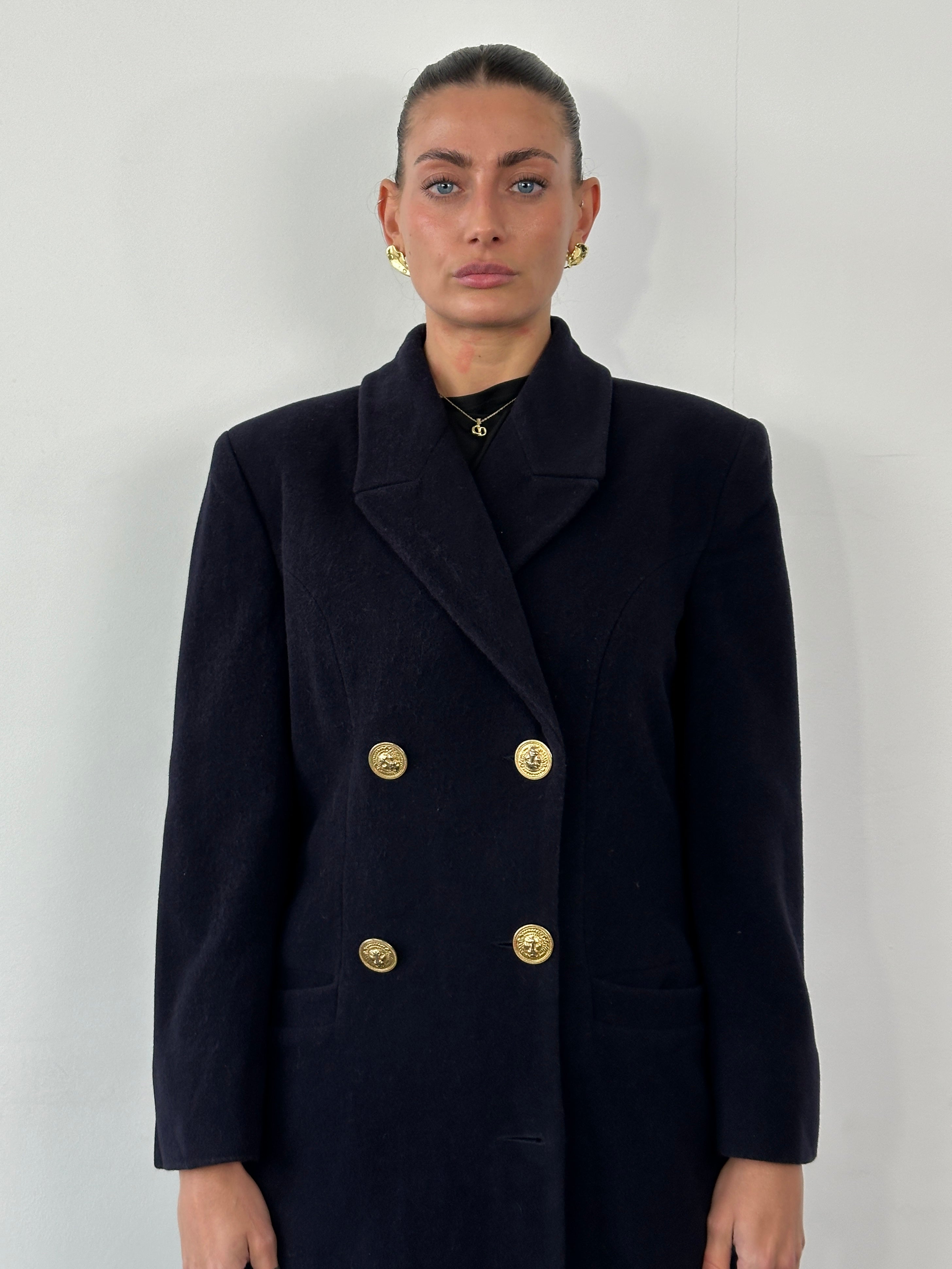 Versace Versus 1990s bespoke double-breasted coat in tailored fabric, featuring classic buttons and a sleek silhouette, size M.