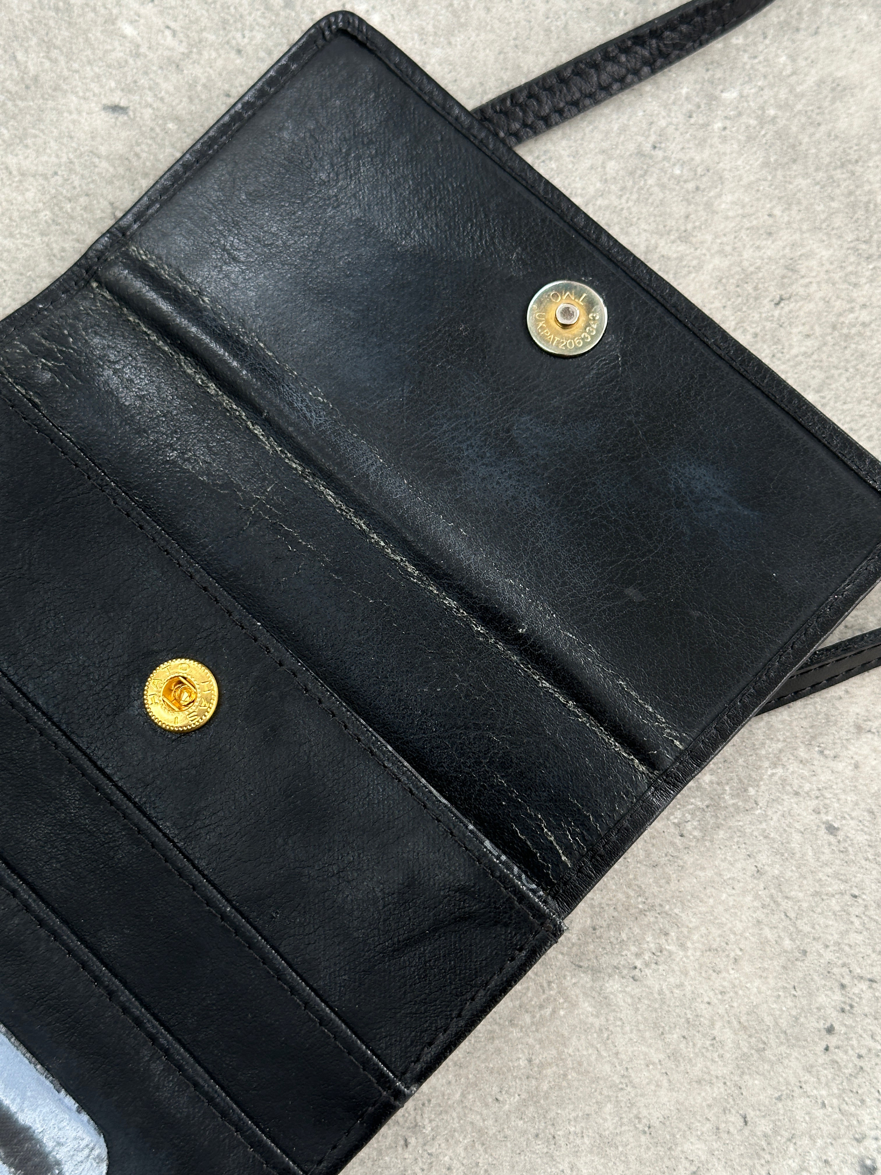 Armani leather crossbody bag featuring Gianni Versace 1990s Medusa design with a sleek, structured silhouette and bold details.