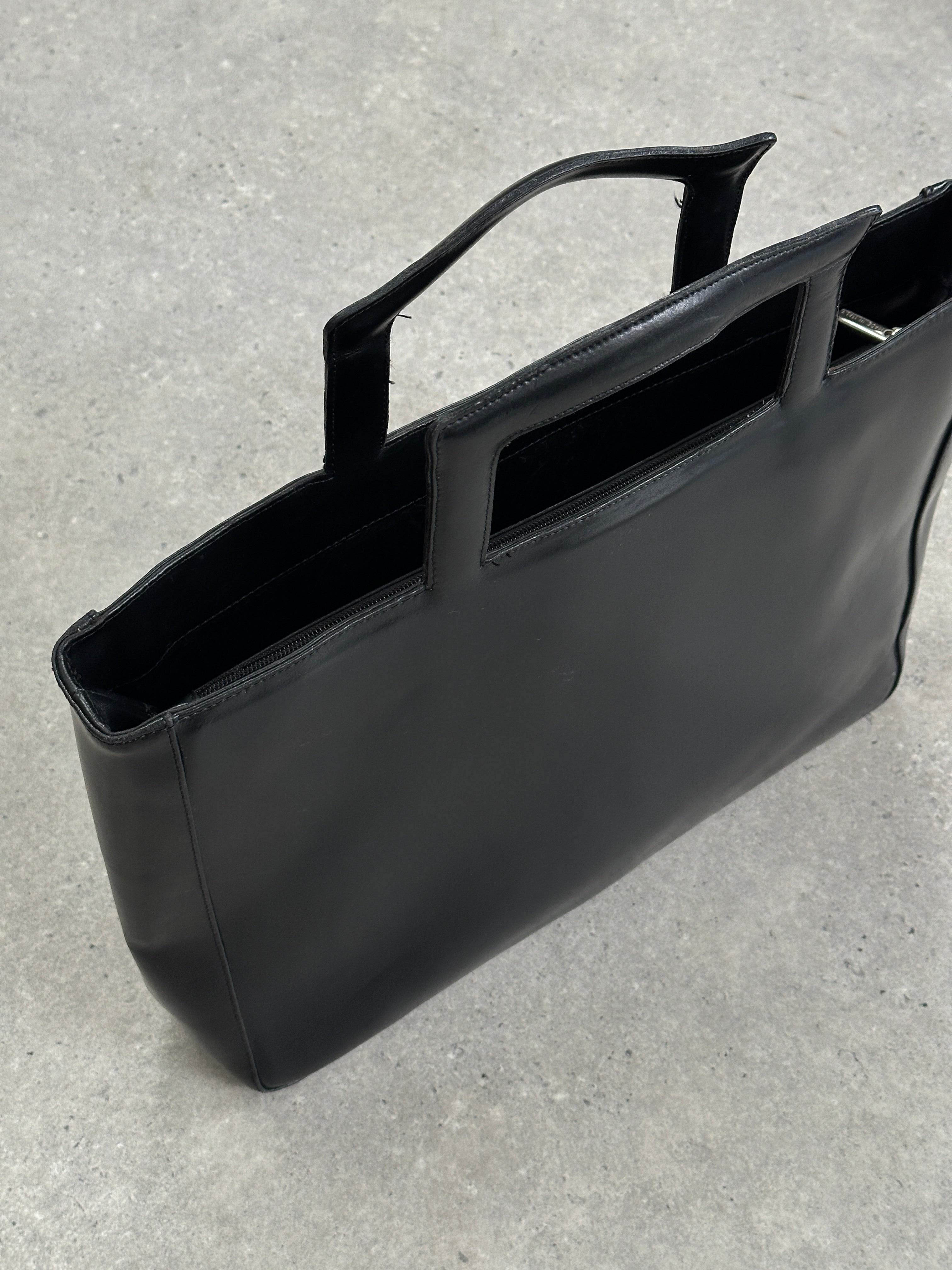 Vintage Italian leather briefcase bag with handles, classic design, and polished finish for professional use.