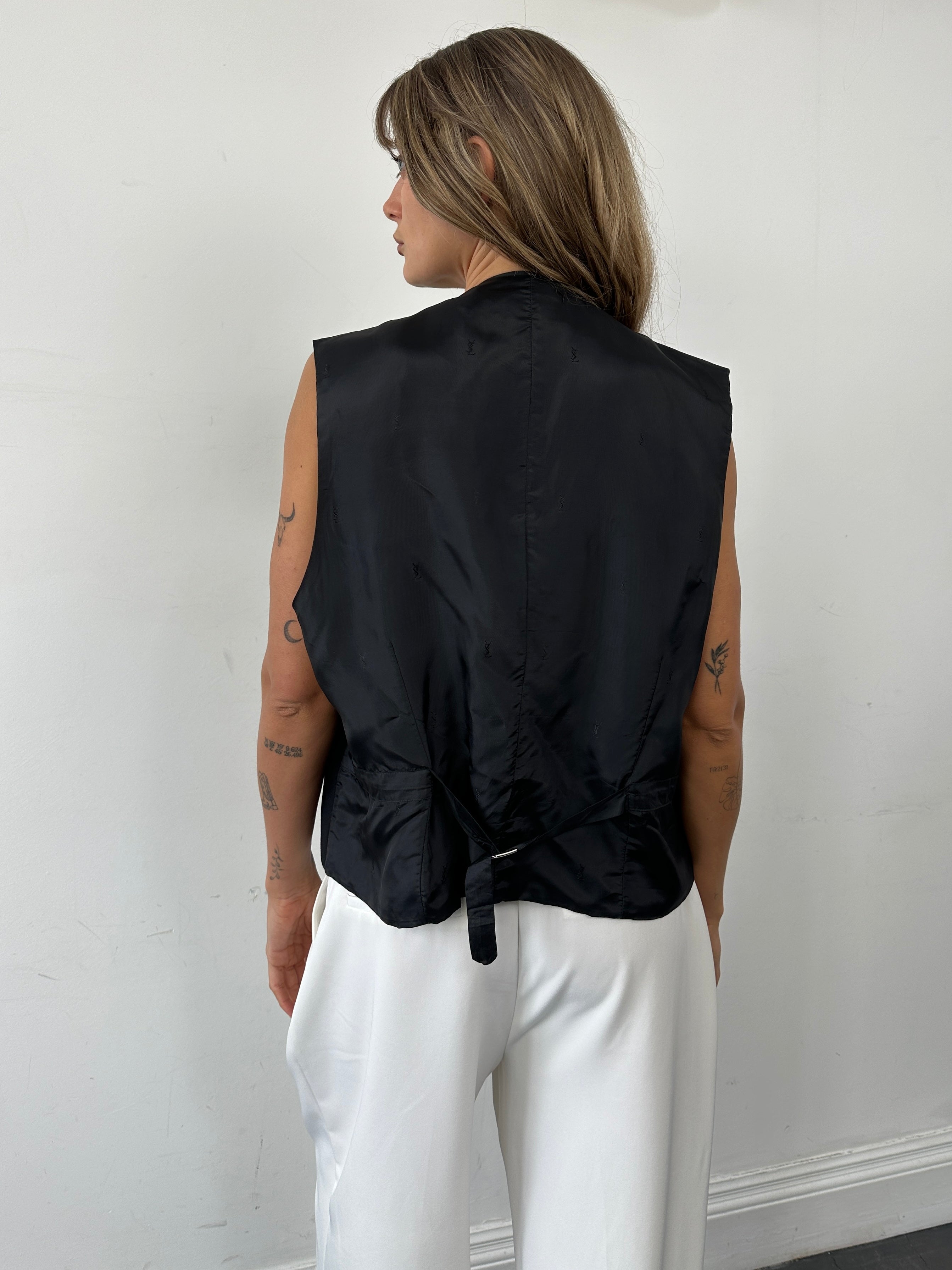 Yves Saint Laurent pure wool tailored waistcoat in size 46R/XL, displayed on a hanger showing classic design and structured fit.