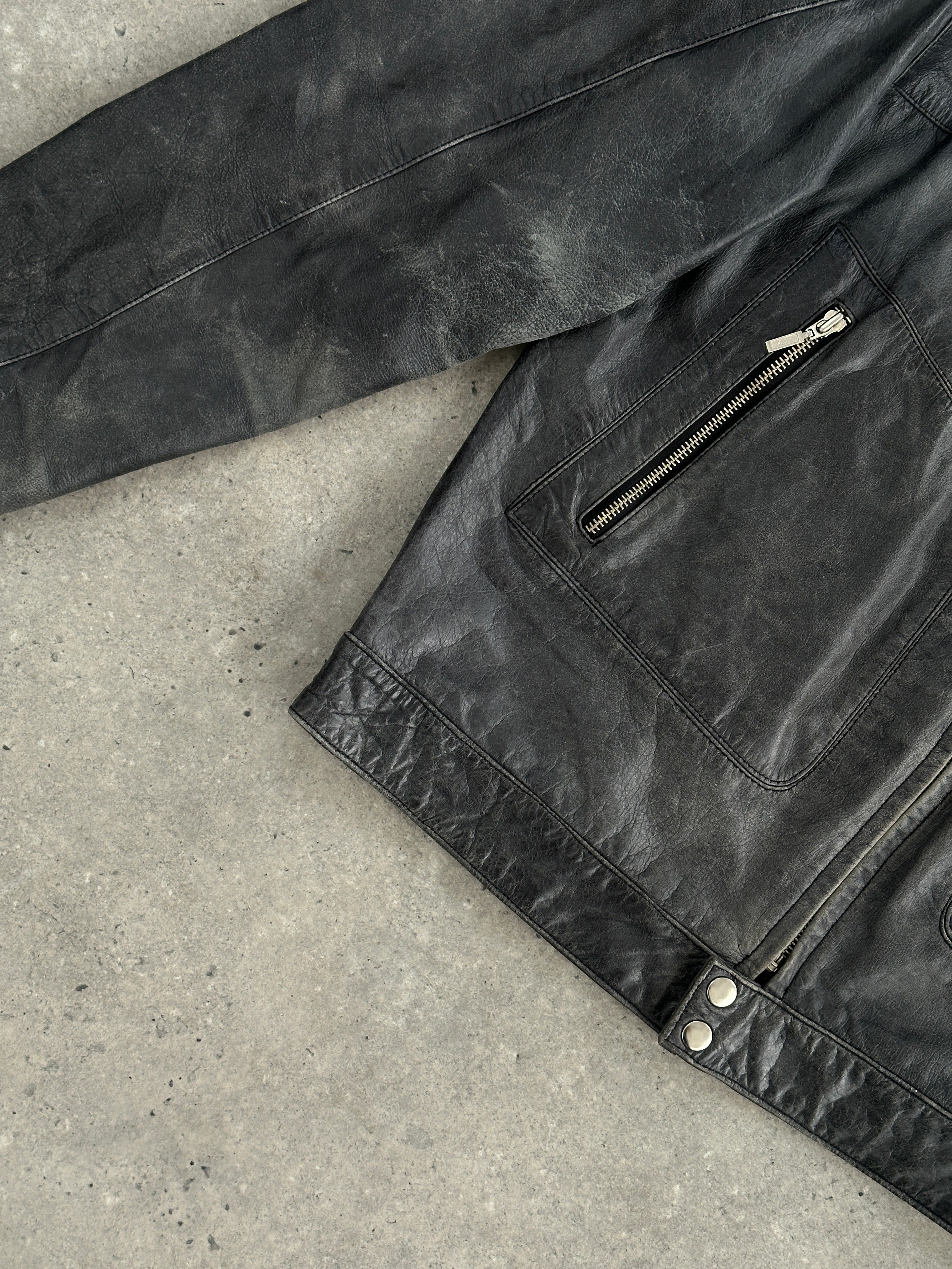Vintage distressed leather moto jacket in size L/XL, featuring a rugged style and classic motorcycle jacket design.