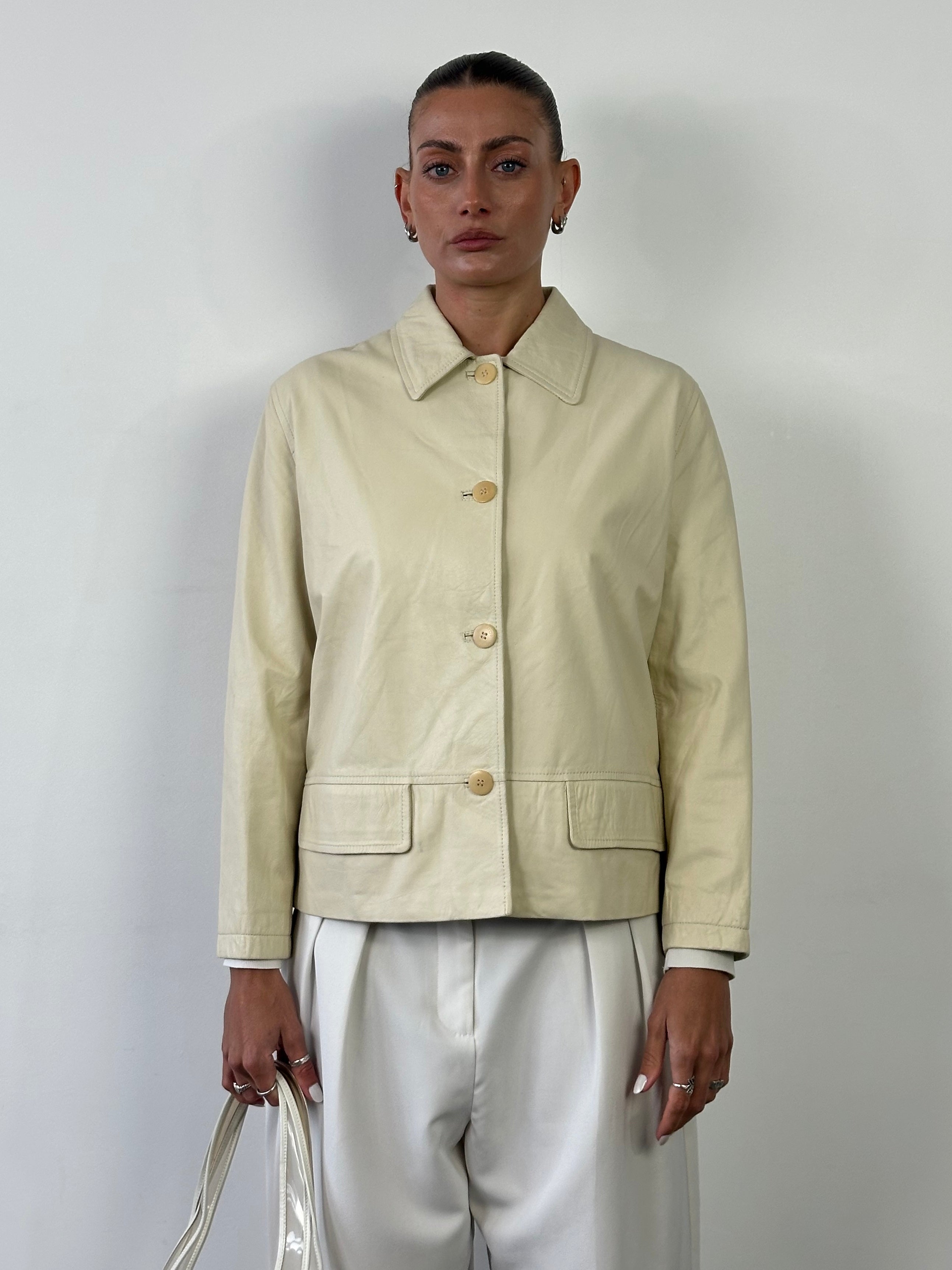 Burberry boxy leather jacket in black with sleek design and classic collar, displayed on a hanger.