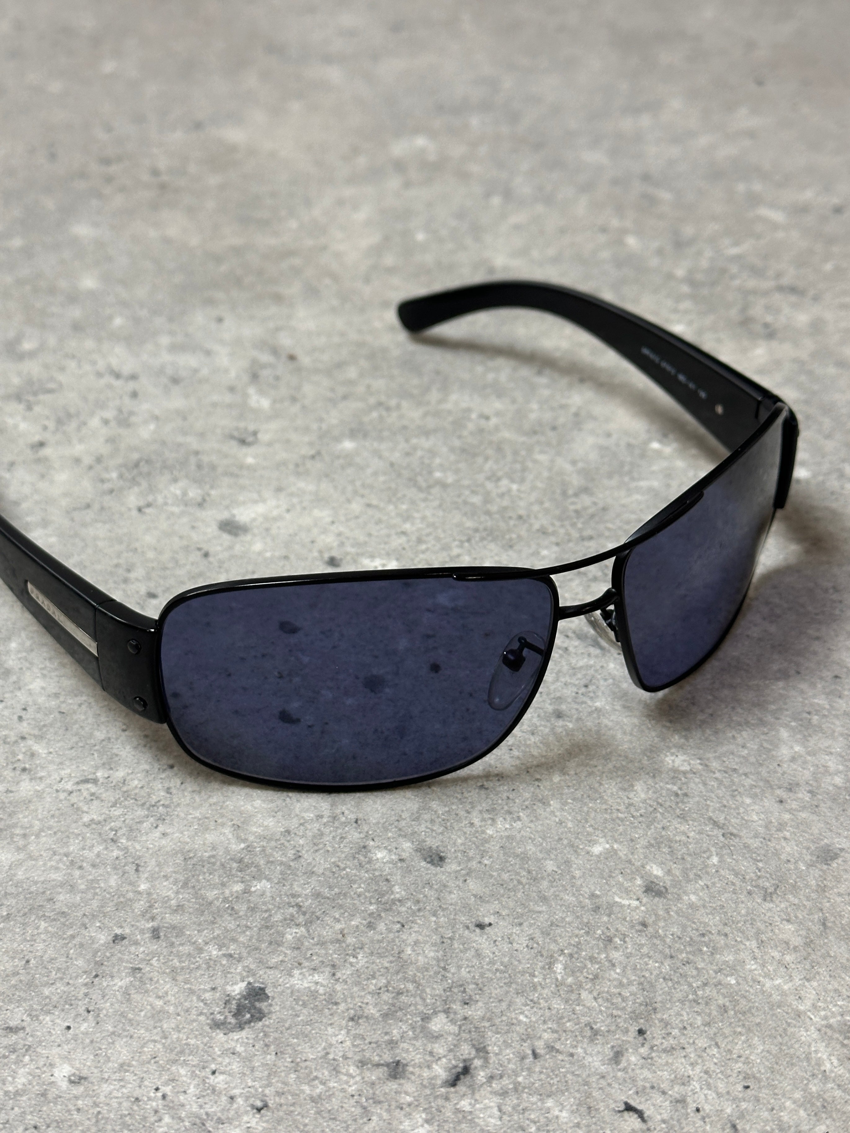 Prada aviator shield sunglasses with large metallic frames and dark tinted lenses, stylish and protective eyewear.