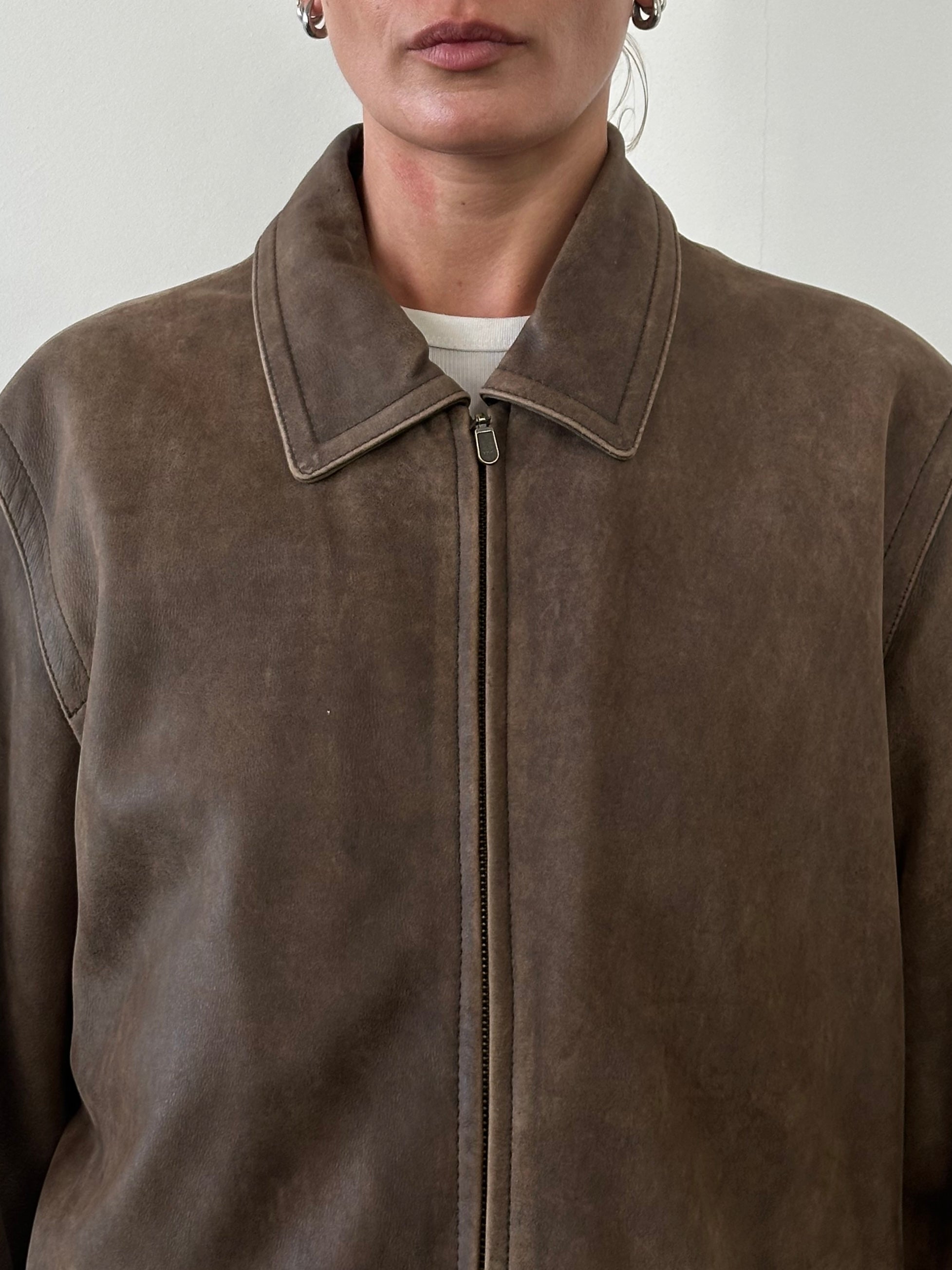 Vintage distressed leather jacket in size large, featuring rugged style and classic design from the Vintage brand.