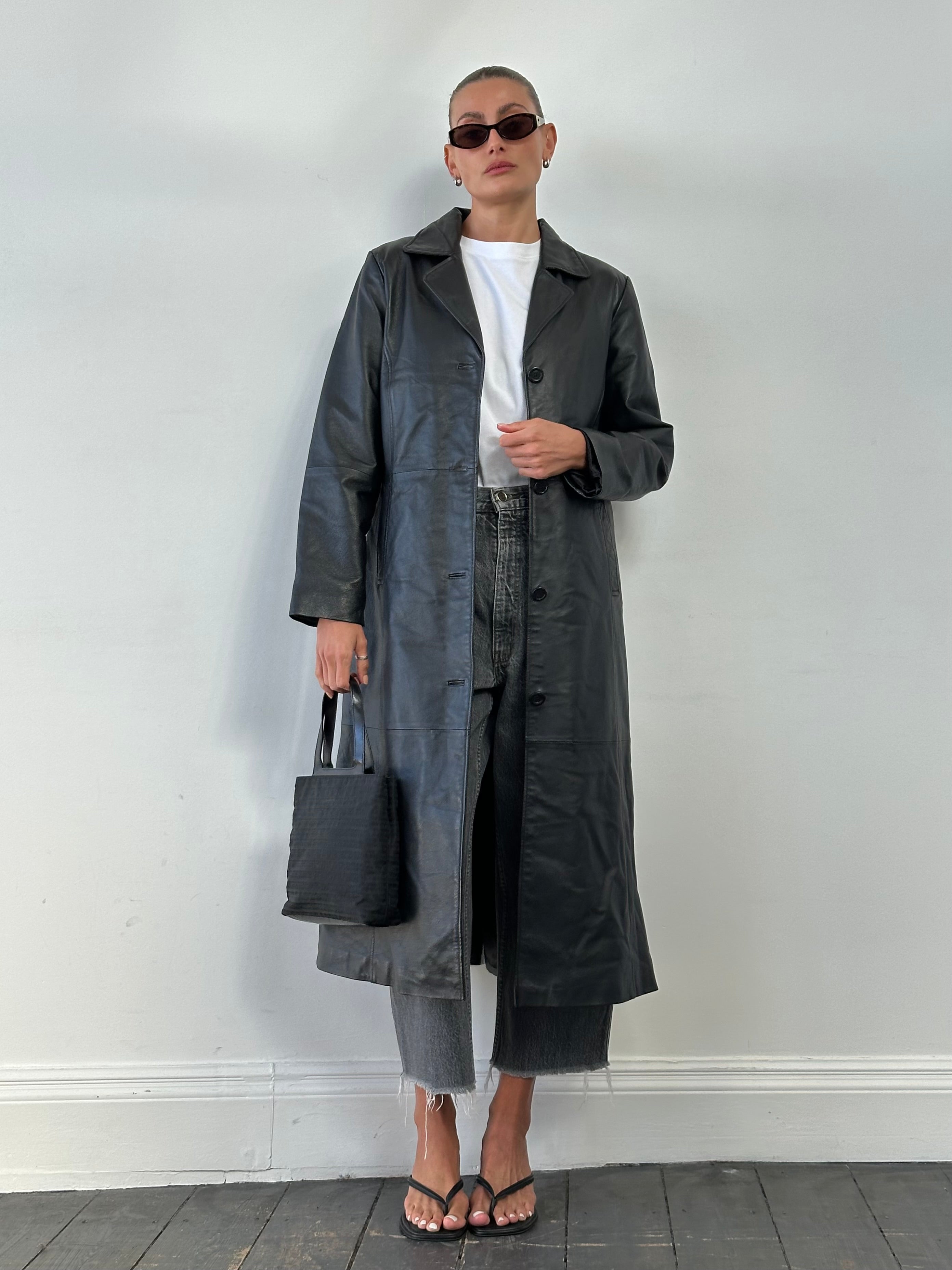 Vintage leather trench coat, floor length jacket in size M, stylish vintage outerwear with classic design and leather texture.