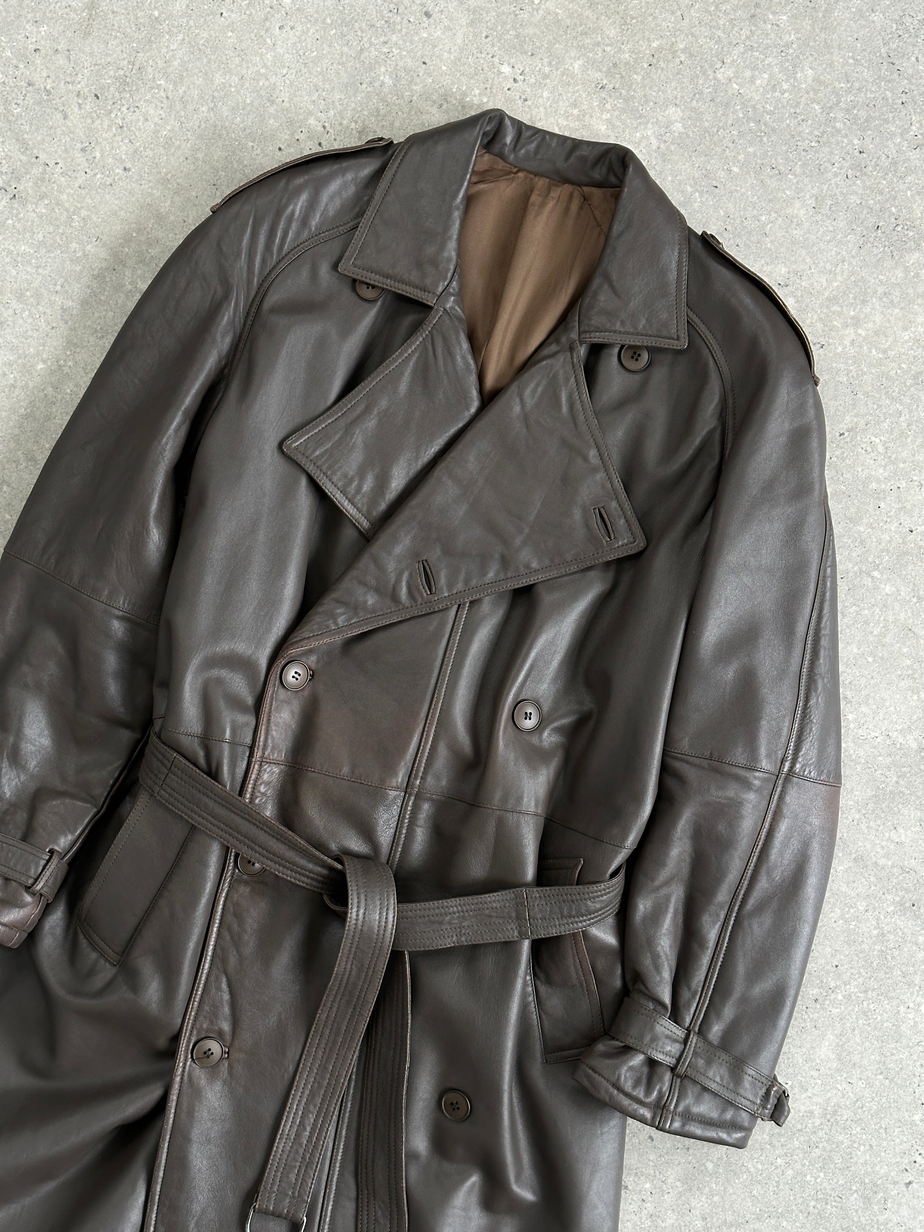 Vintage leather double-breasted belted trench coat in size L, featuring classic design and textured leather material.