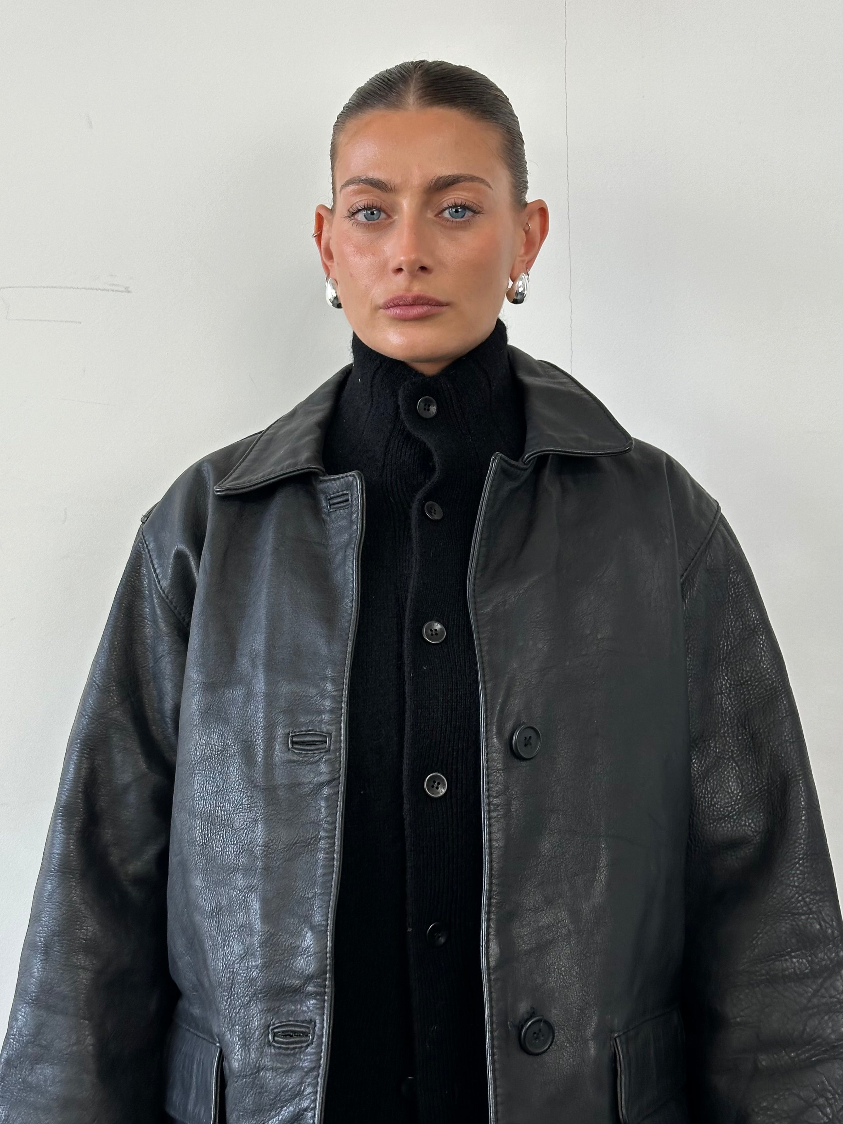 Vintage leather jacket in size M, featuring classic design and brown leather material with visible stitching and a front zipper.