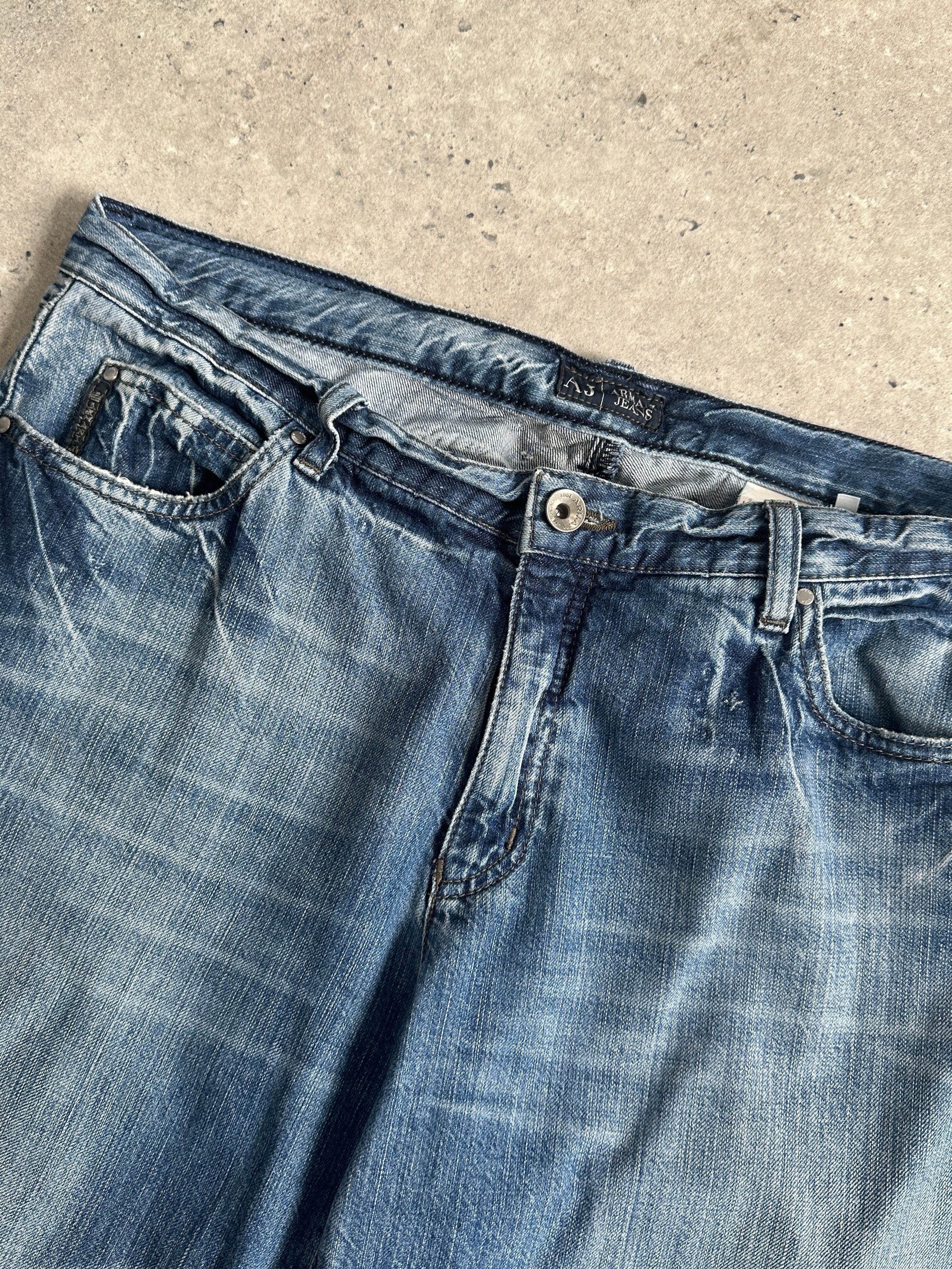 Armani Jeans stonewashed mid-waist denim jeans in size W34, showcasing classic fit and faded blue fabric.