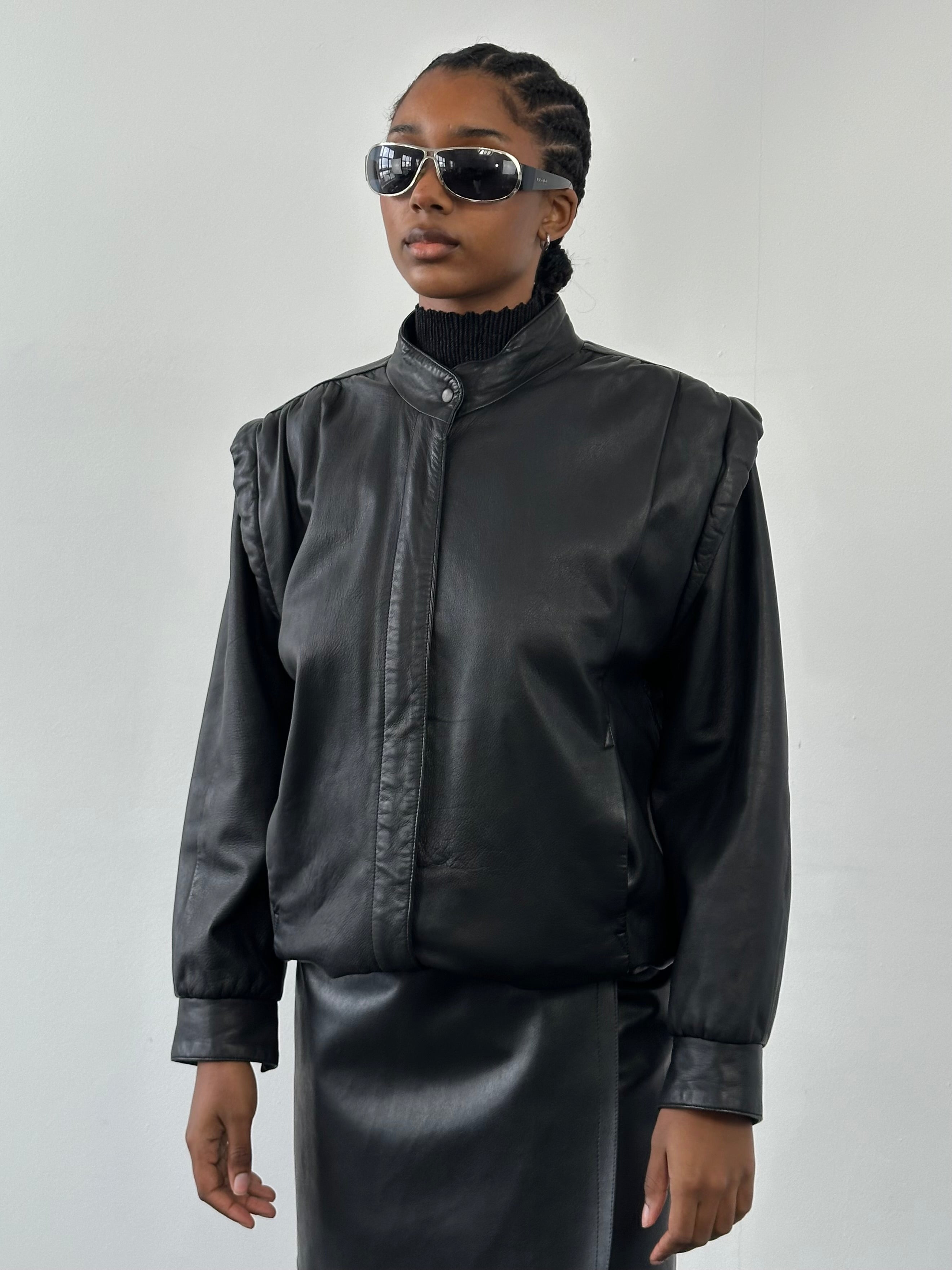 Vintage 1990s leather bomber jacket in medium size, featuring classic design and authentic leather texture.