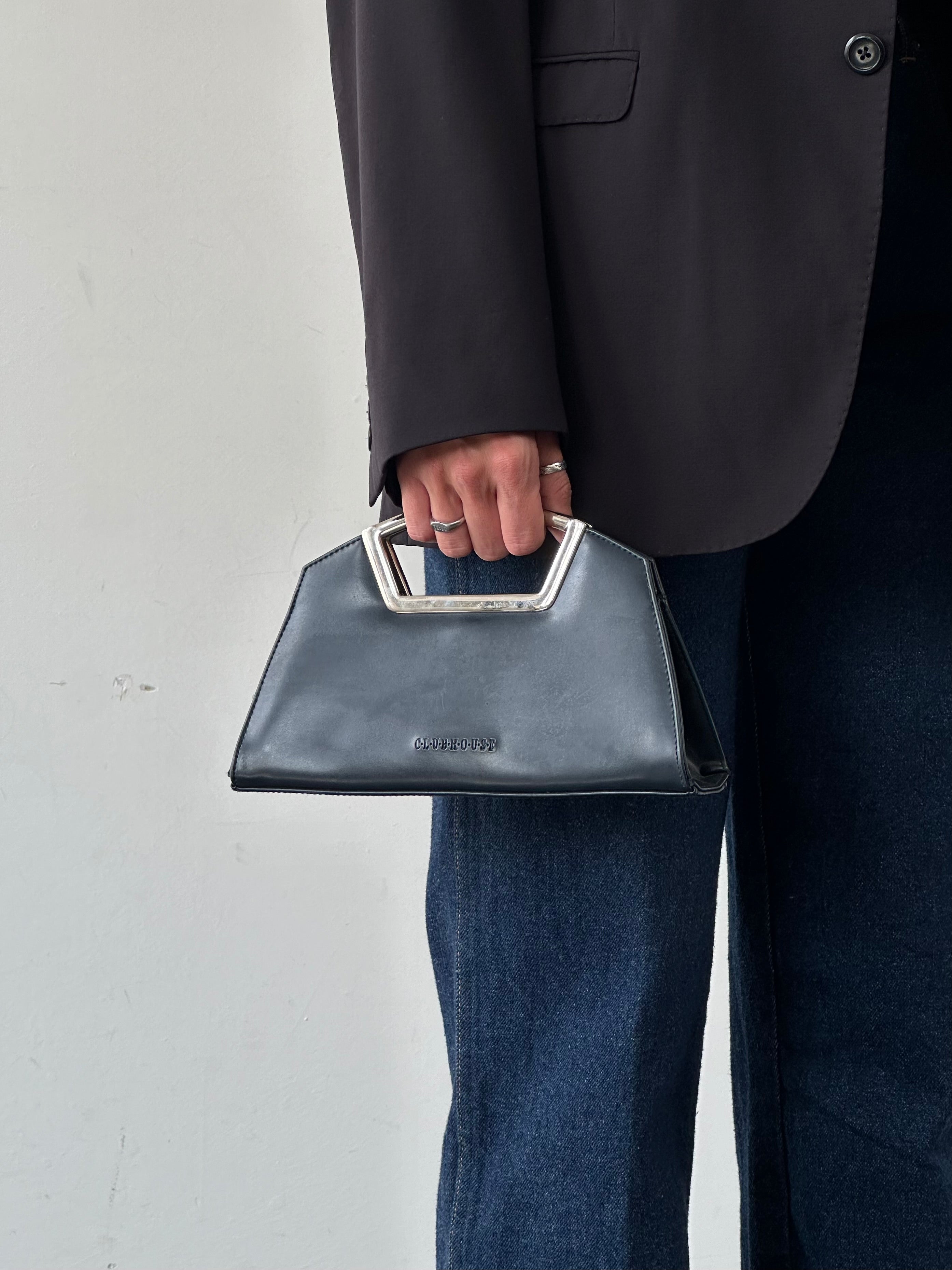 Vintage leather chrome crossbody clutch bag with sleek design and adjustable strap, perfect for stylish everyday use.